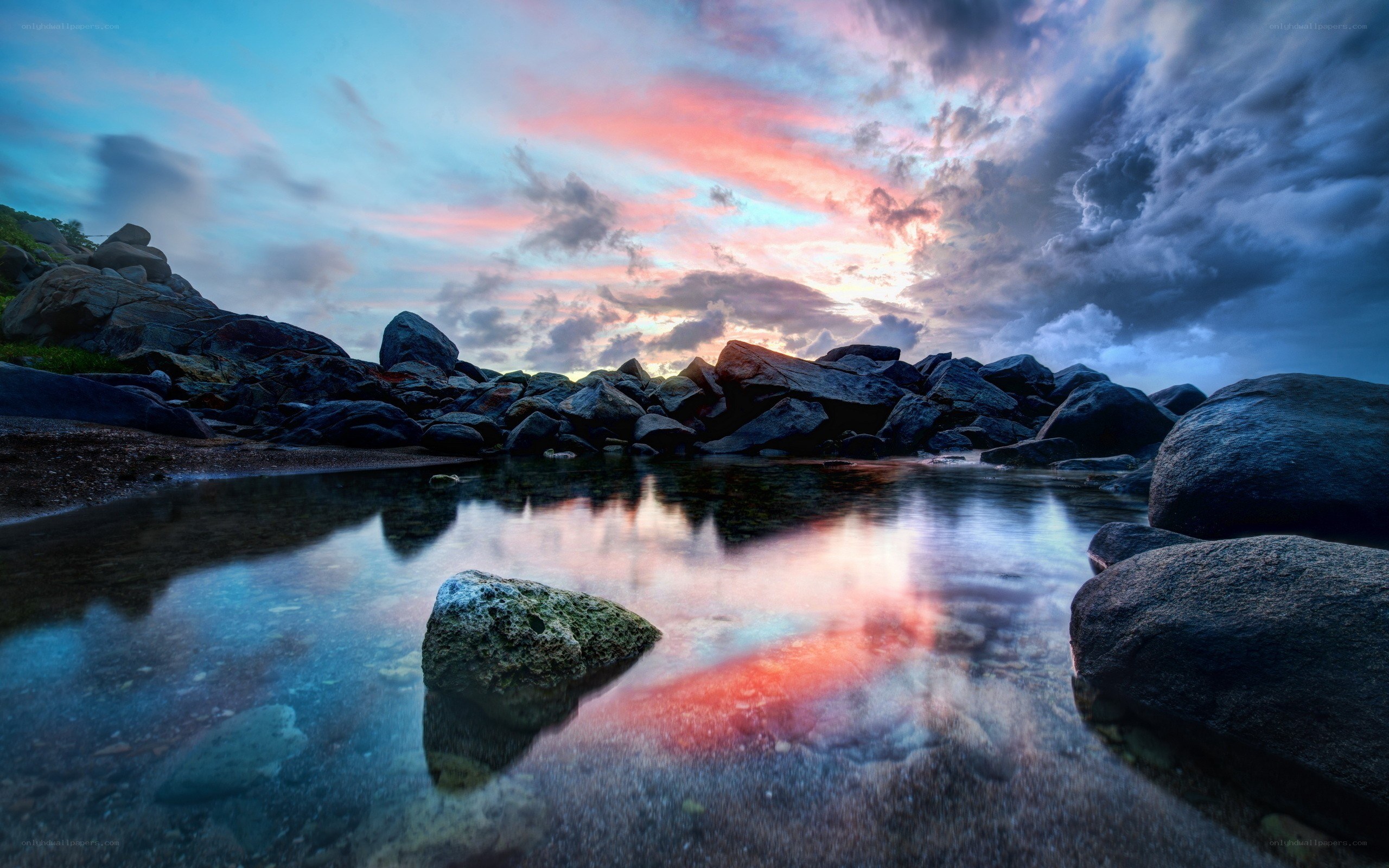 Sunset over rocky shoreline