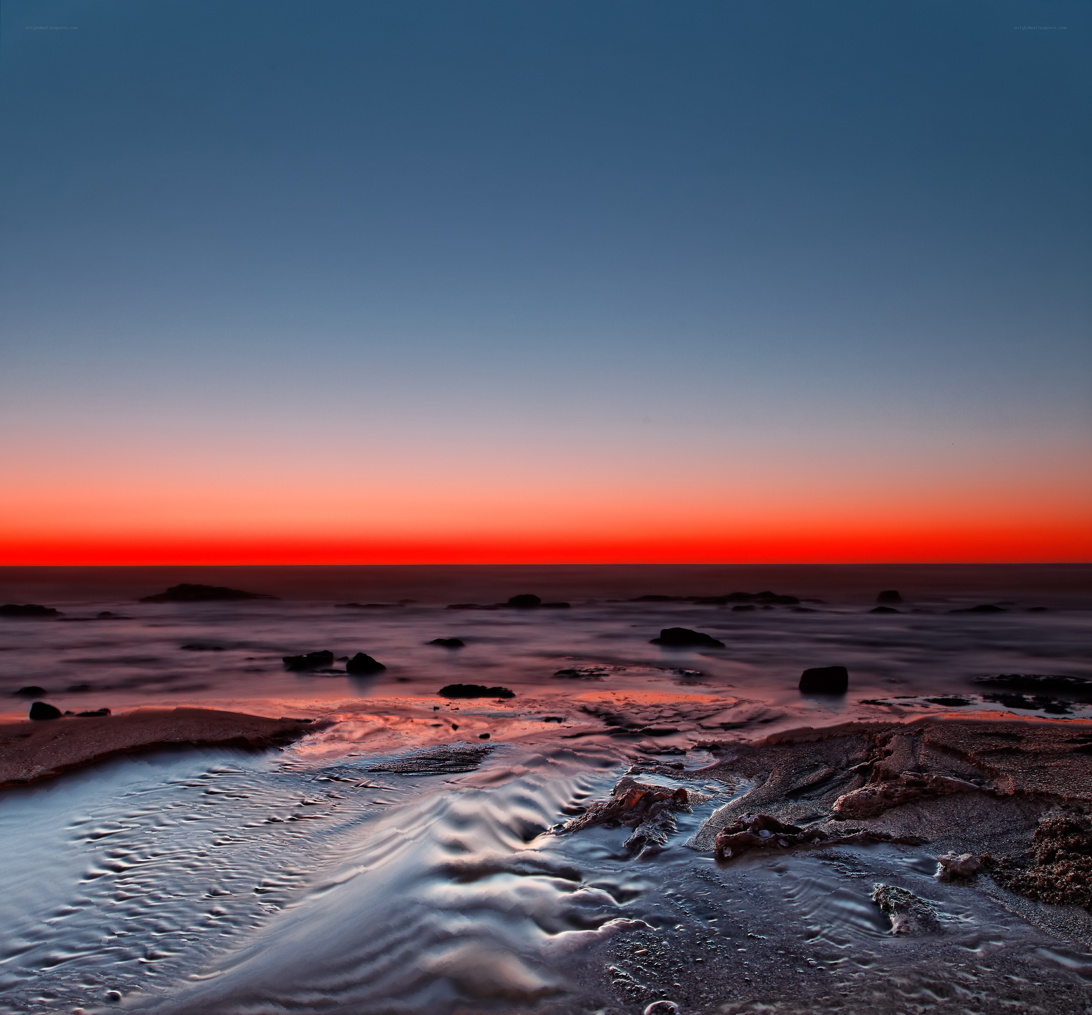 Sunset over rocky shoreline