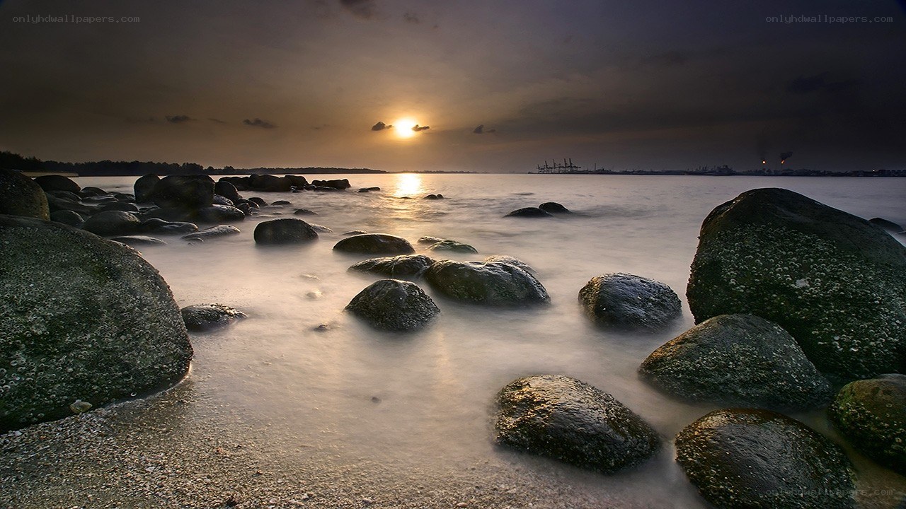 Sunset over rocky shoreline