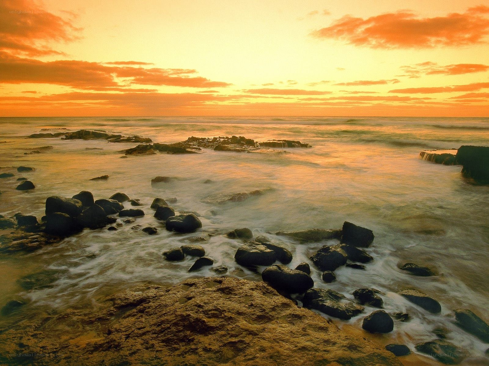 Sunset over rocky shoreline