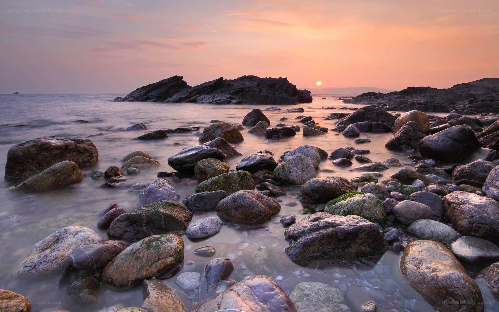 Sunset over rocky shoreline