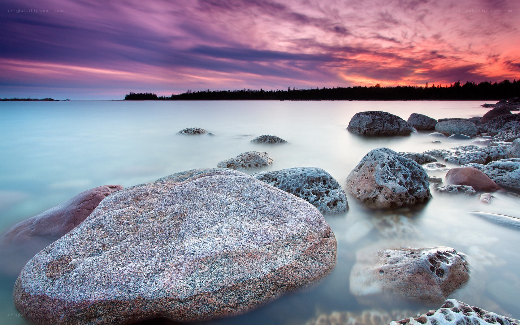 Sunset over rocky shoreline