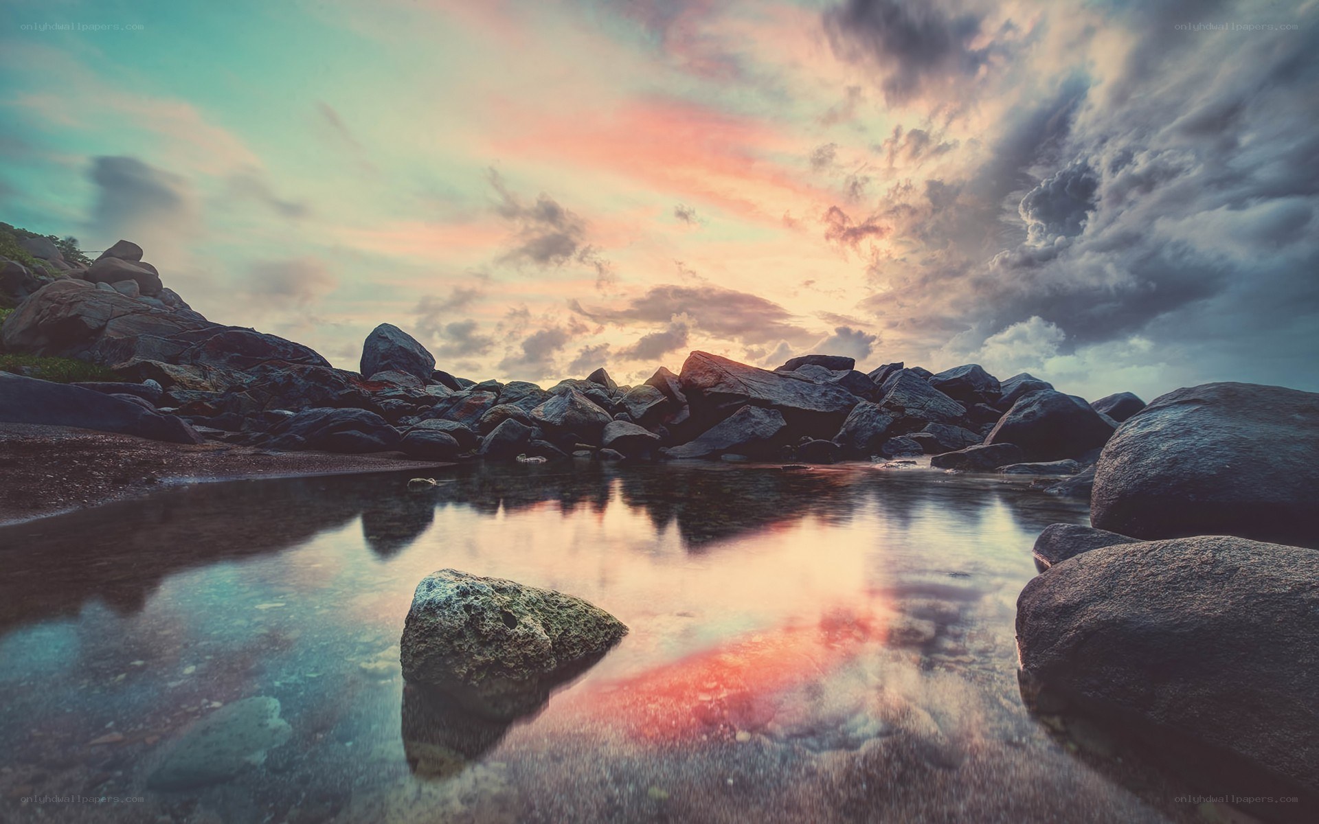 Sunset over rocky shoreline