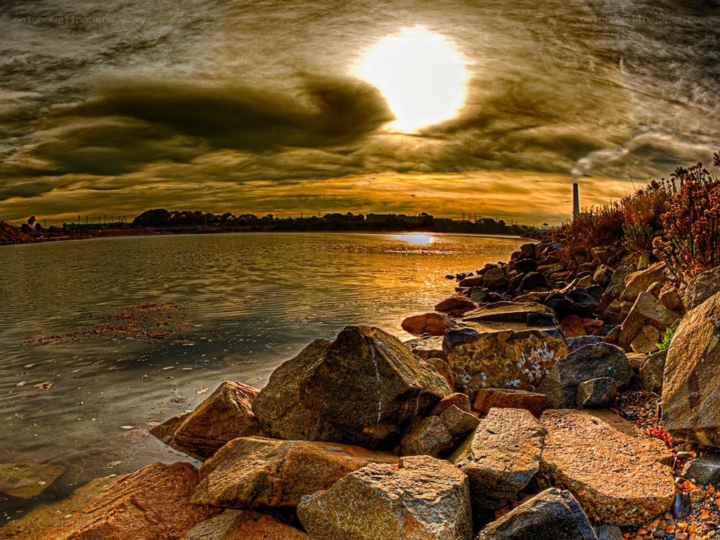 Sunset over rocky shoreline