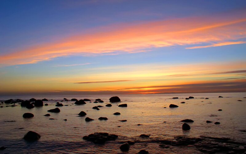 Sunset over rocky shoreline