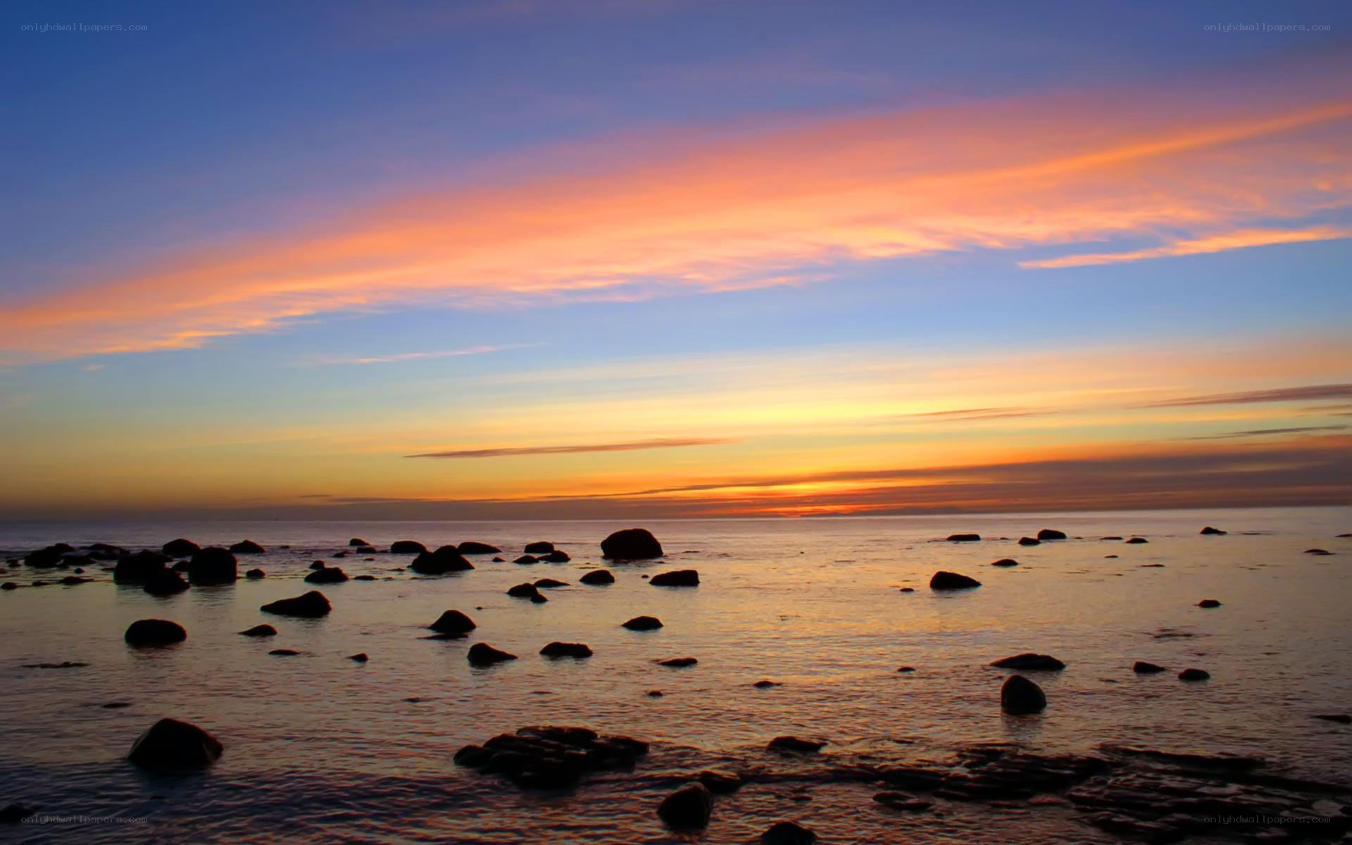 Sunset over rocky shoreline