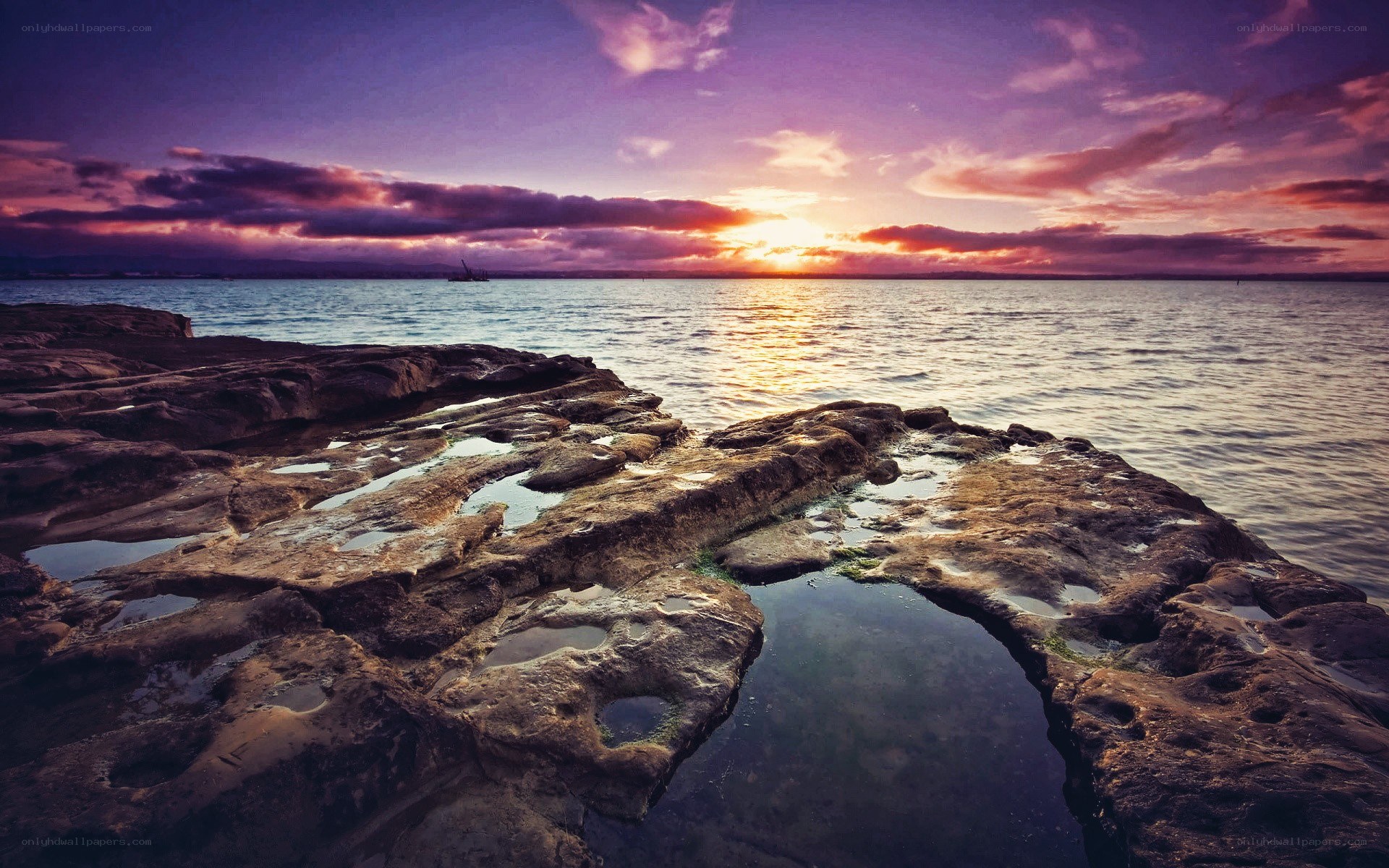Sunset over rocky shoreline