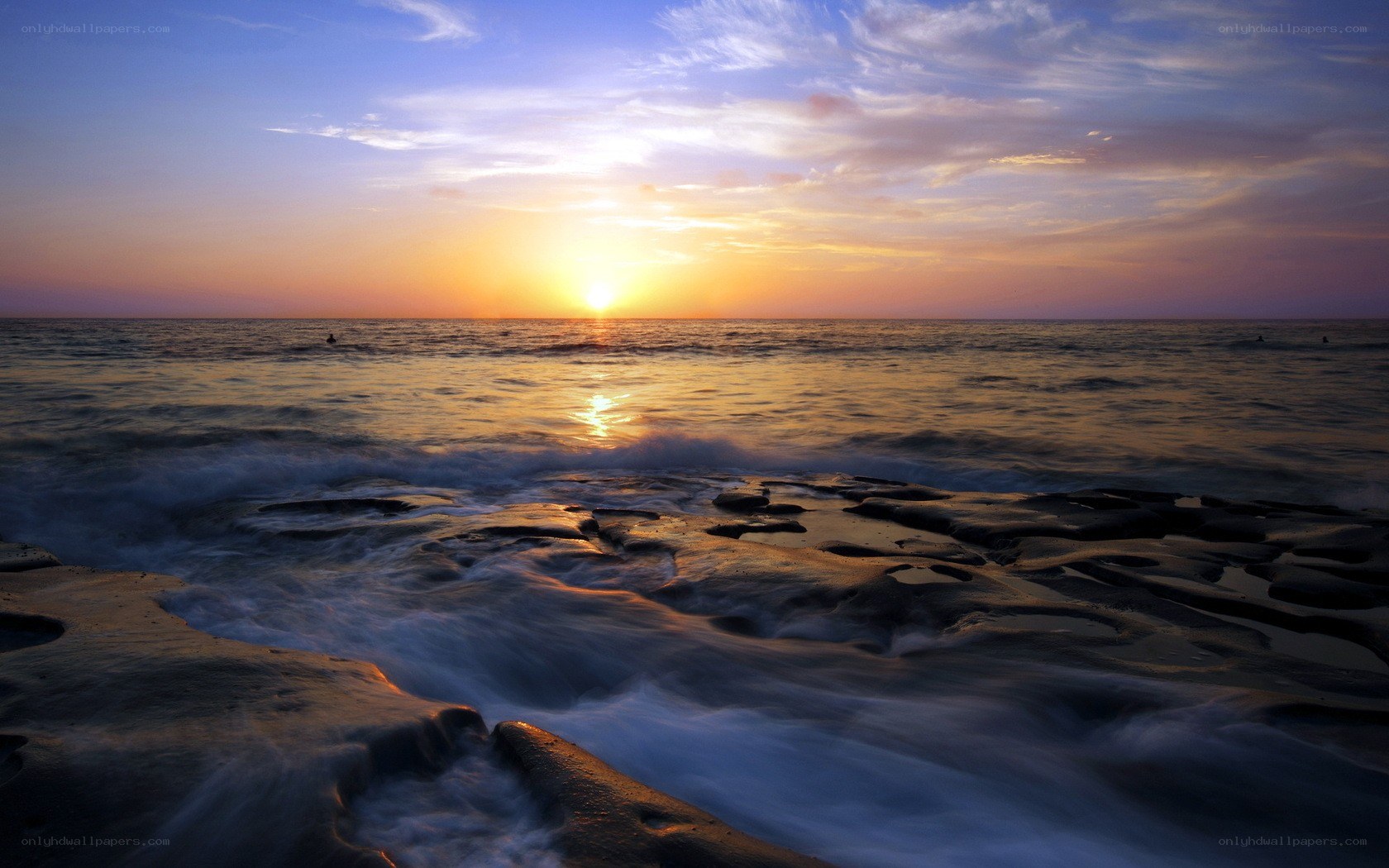 Sunset over rocky shoreline