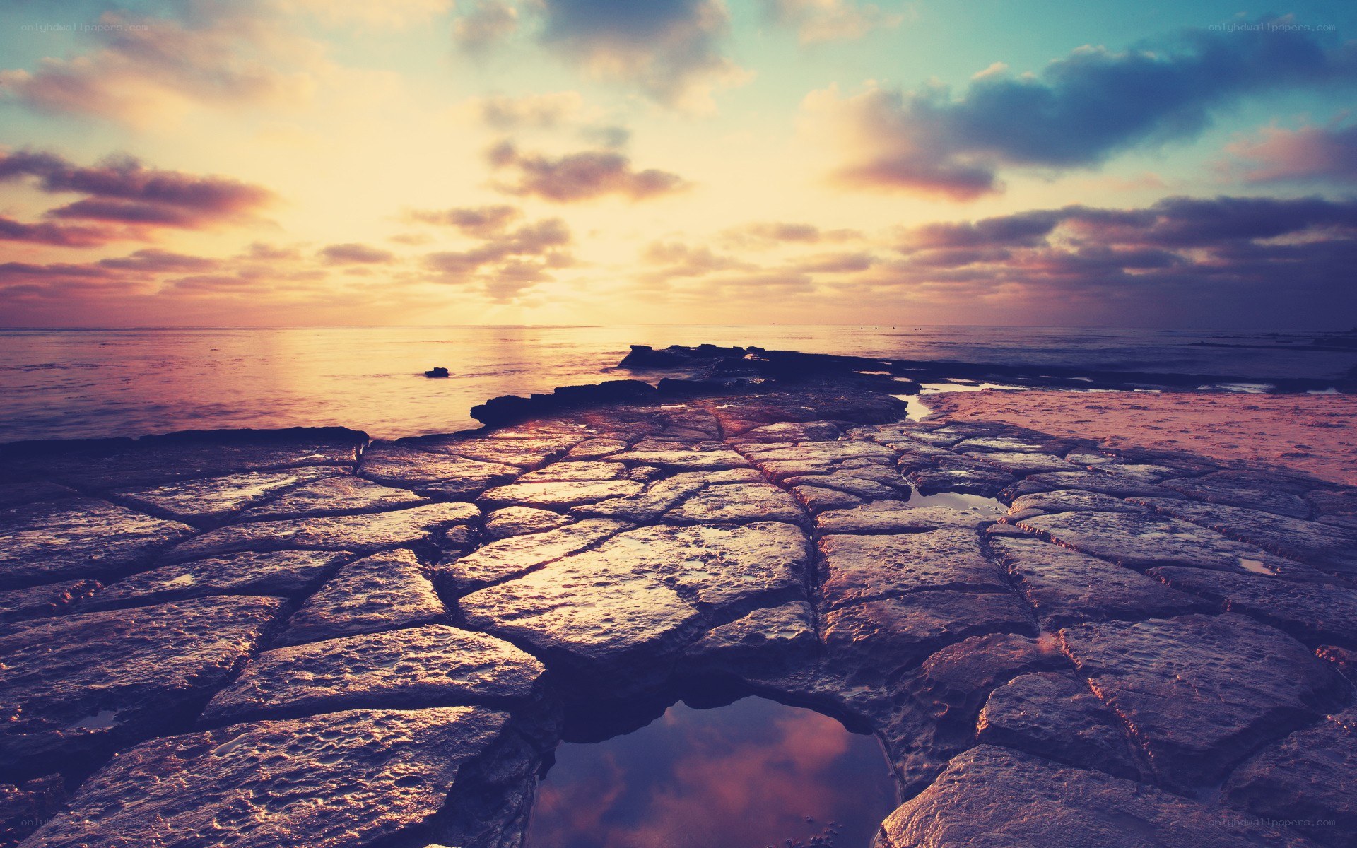 Sunset over rocky shoreline