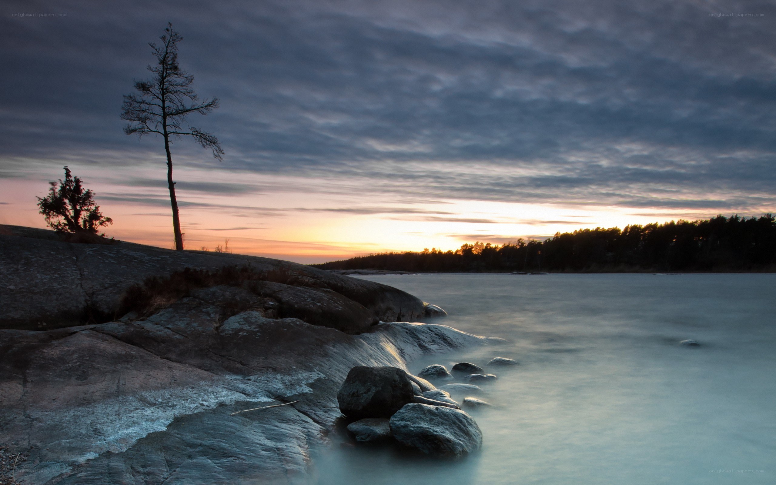 Sunset over rocky shoreline