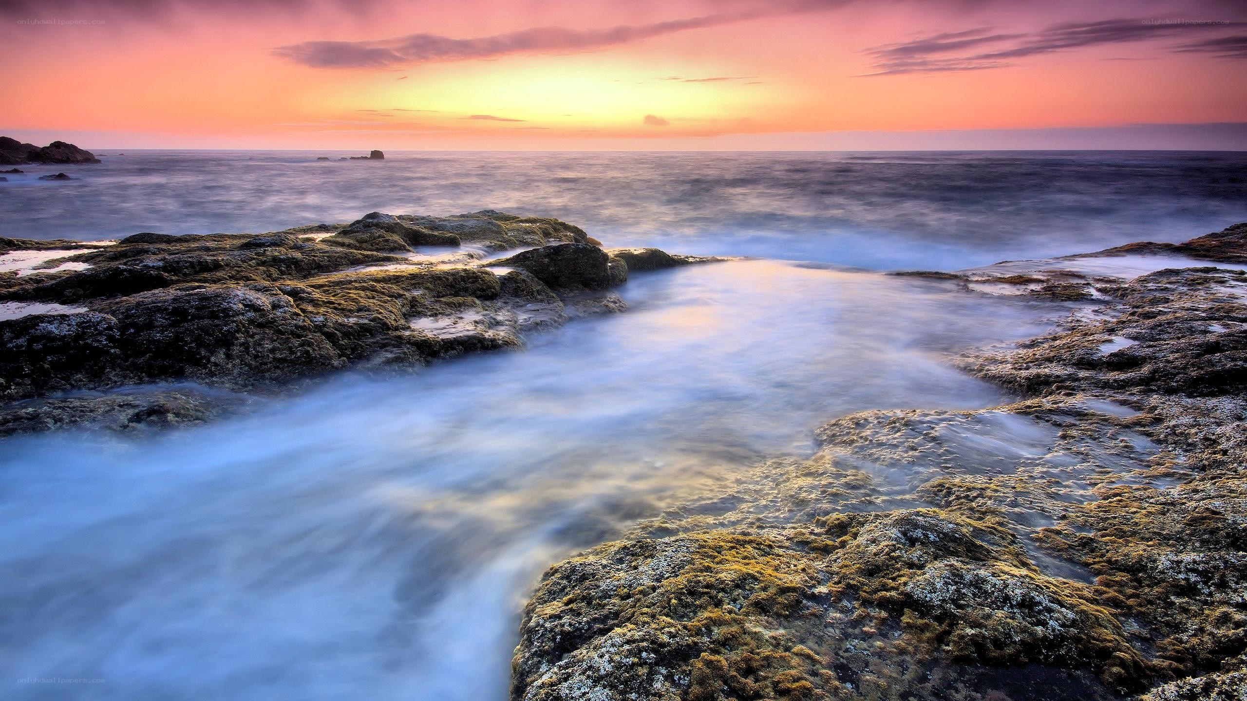 Sunset over rocky shoreline