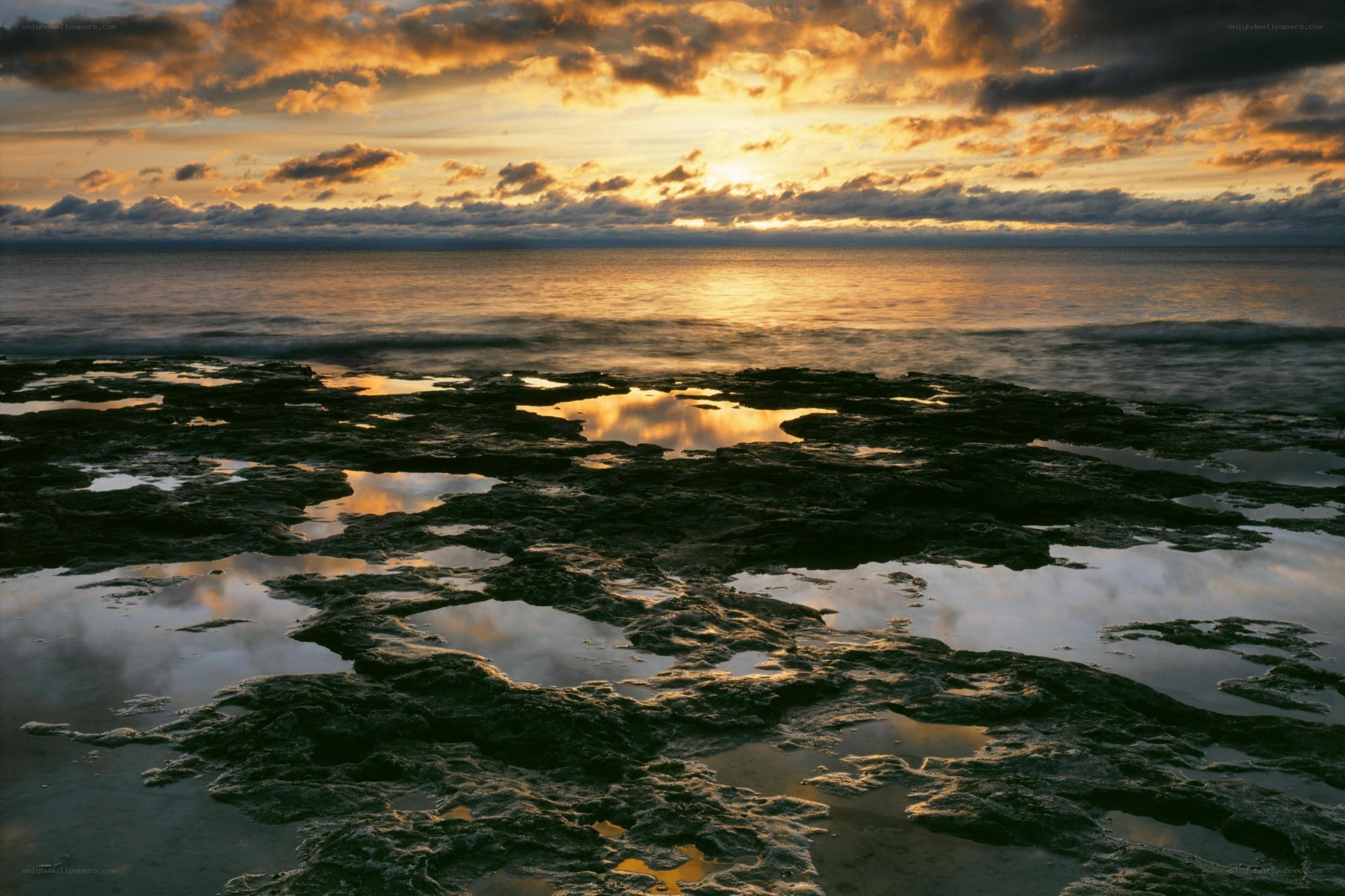 Sunset over rocky shoreline