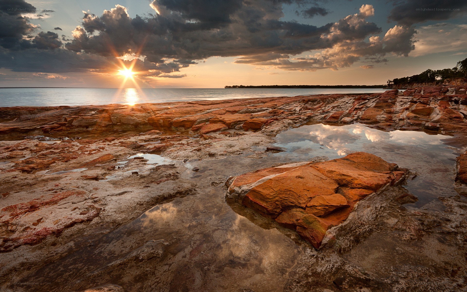 Sunset over rocky shoreline