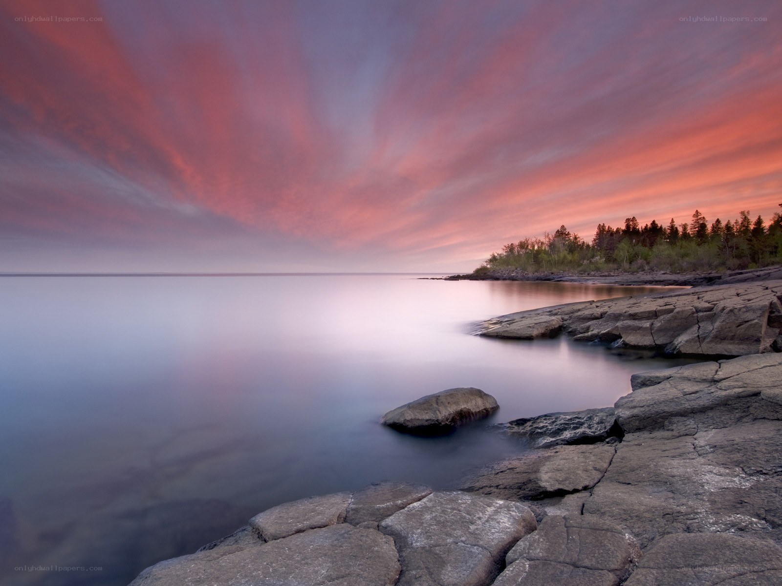 Sunset over rocky shoreline