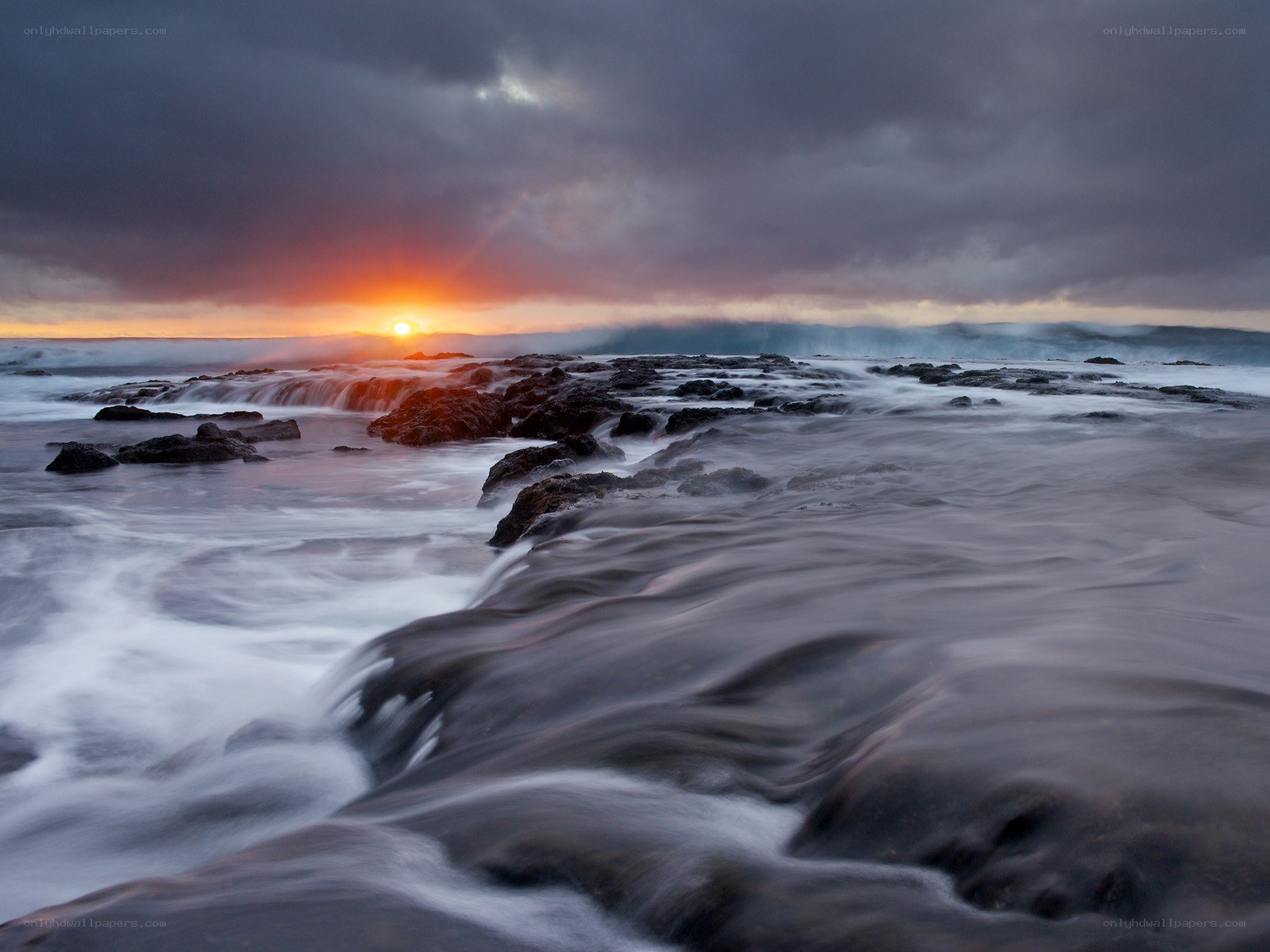 Sunset over rocky shoreline
