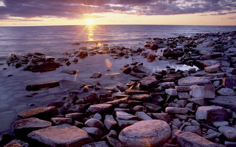 Sunset over rocky shoreline