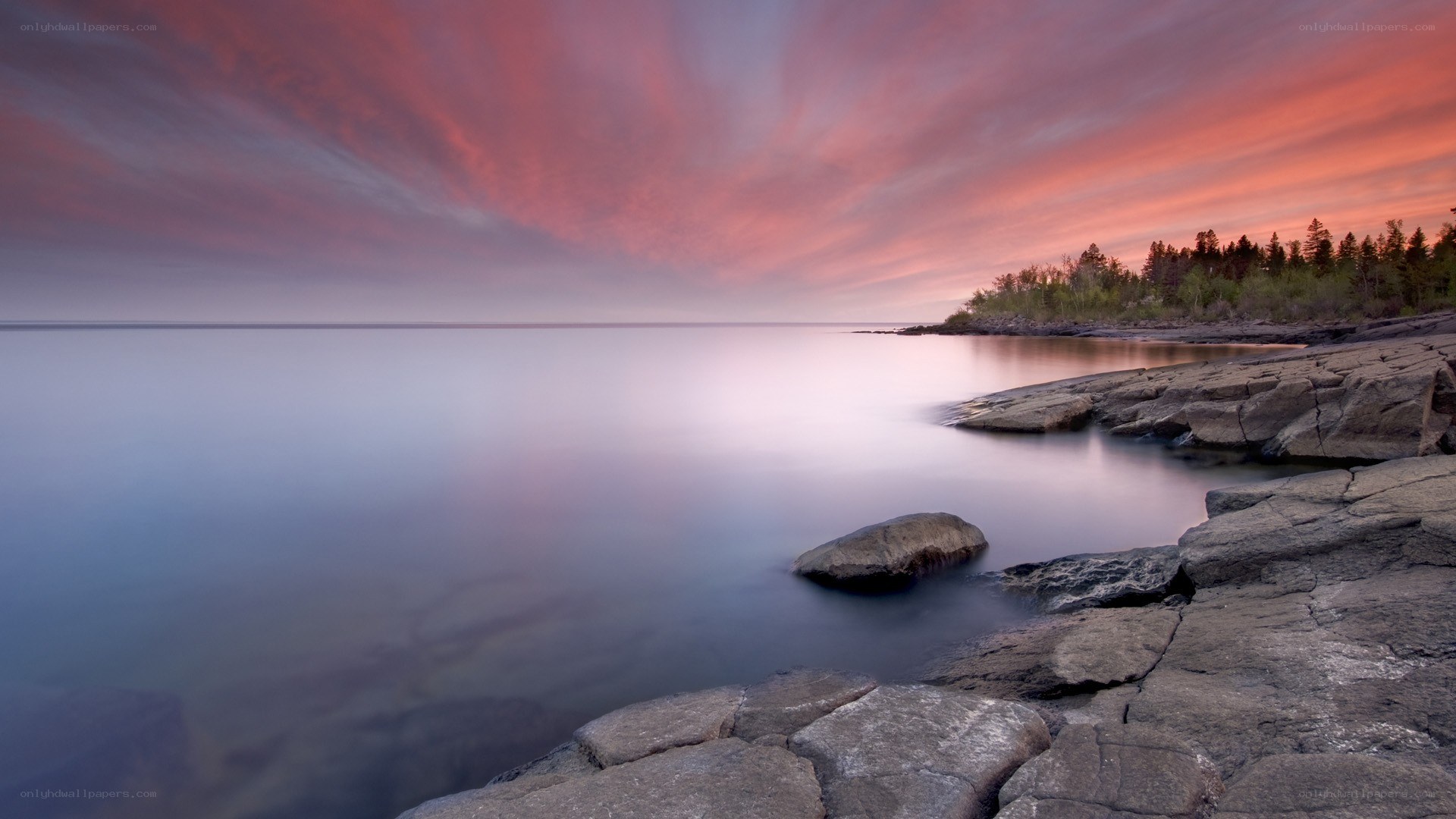 Sunset over rocky shoreline