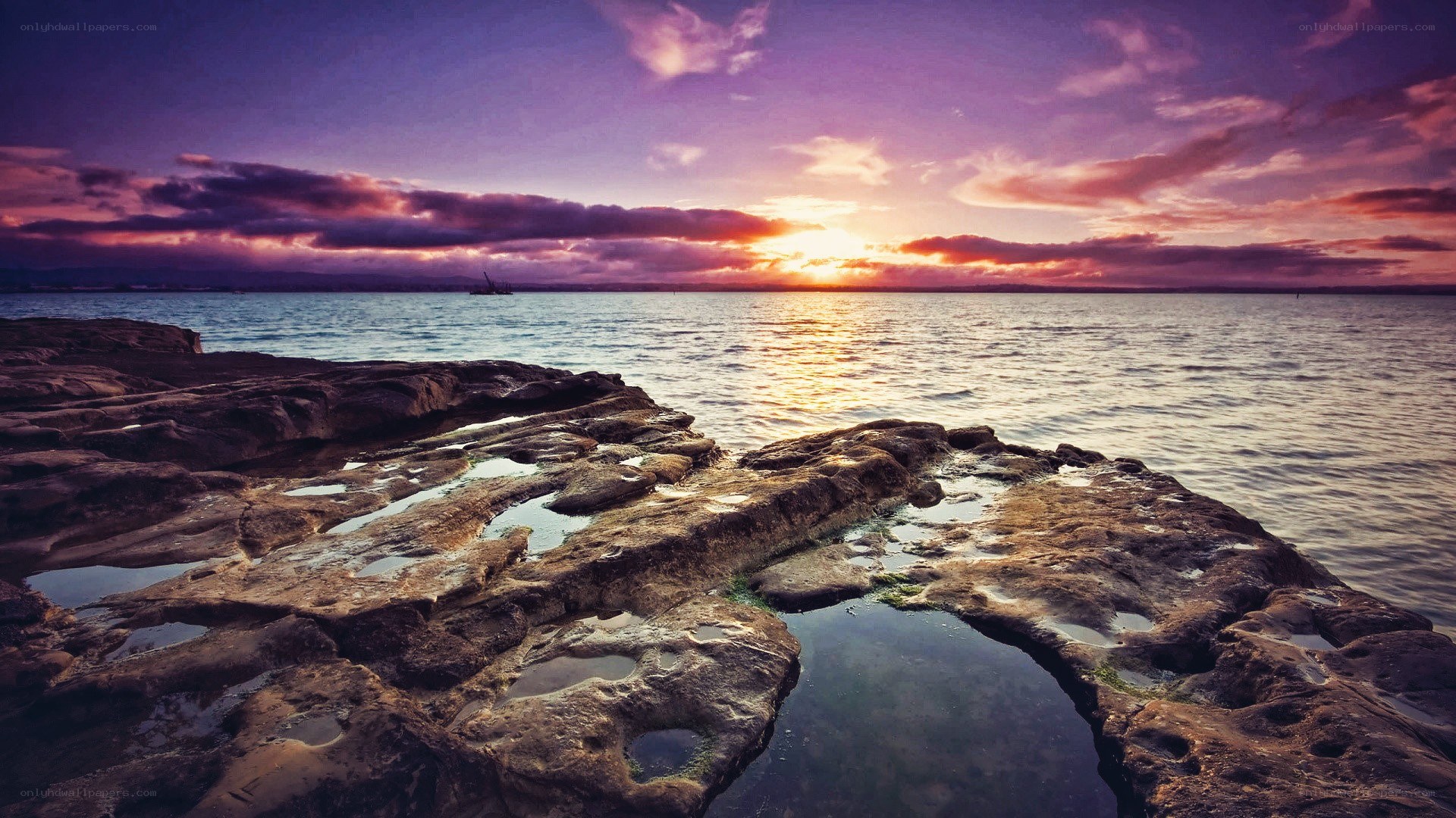 Sunset over rocky shoreline