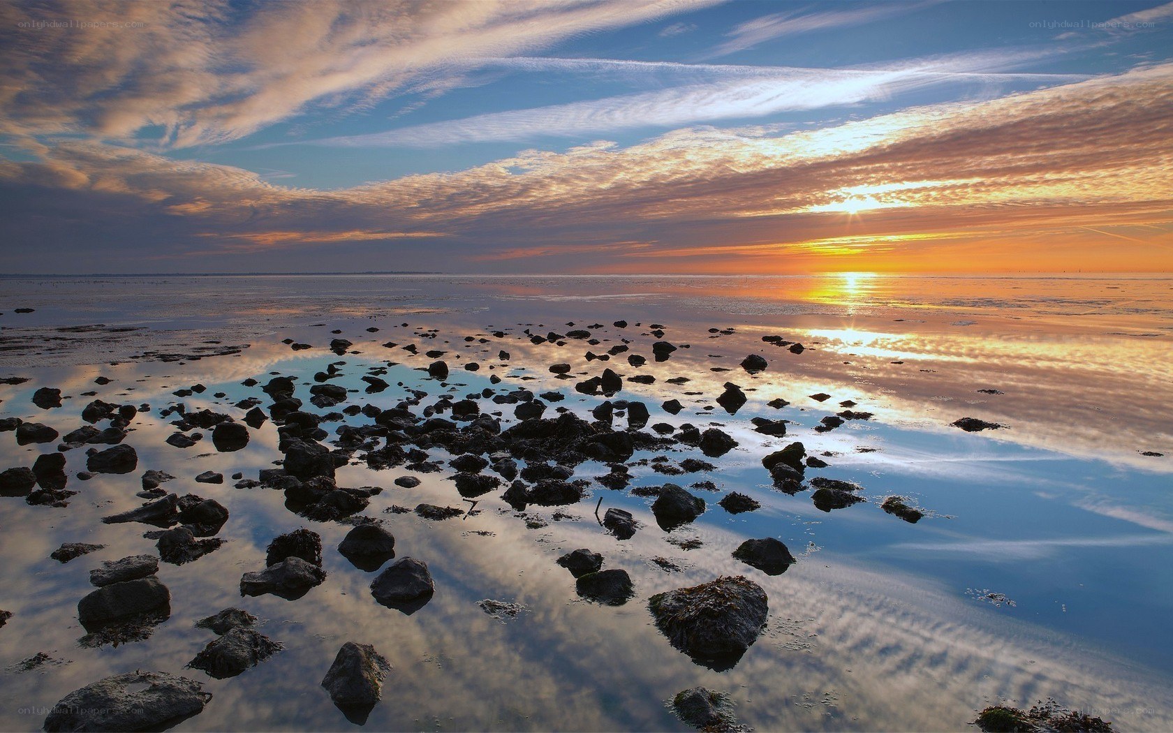 Sunset over rocky shoreline