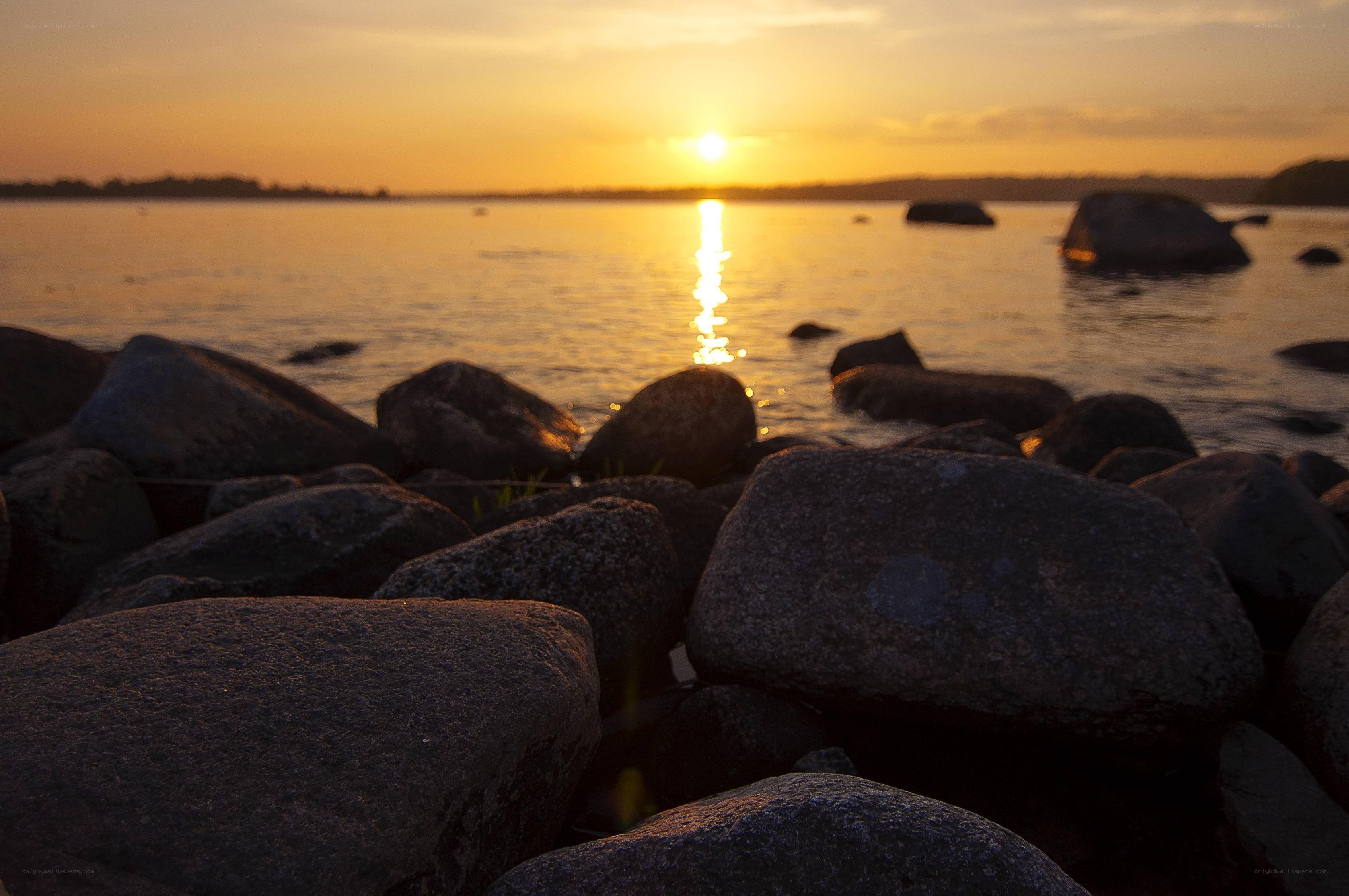 Sunset over rocky shoreline