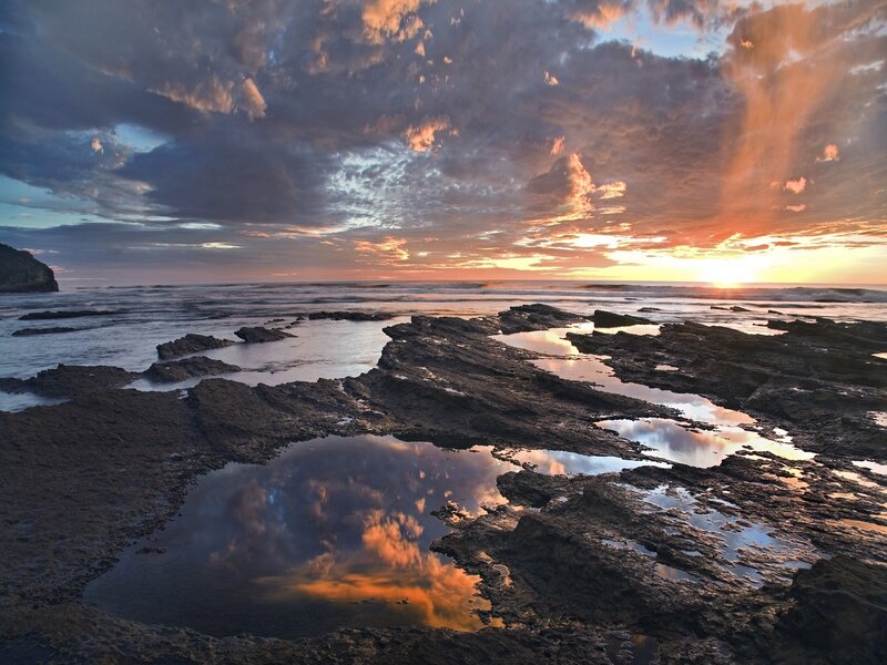 Sunset over rocky shoreline