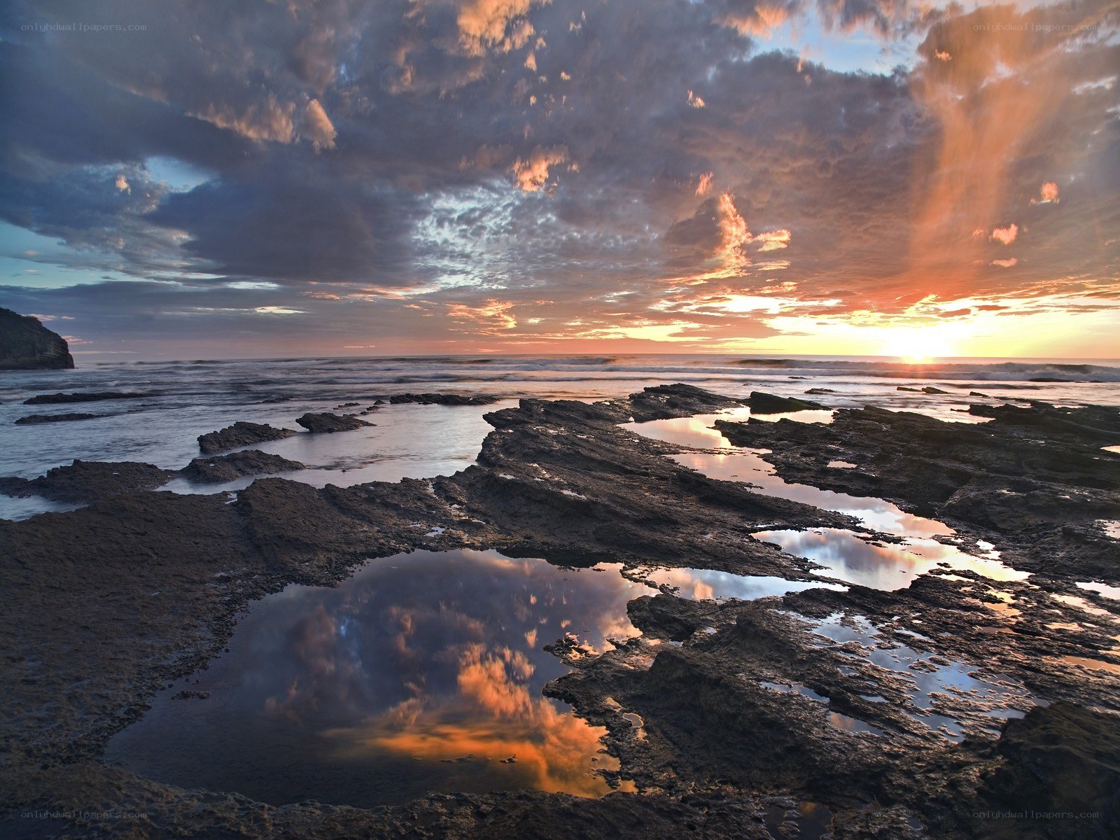Sunset over rocky shoreline