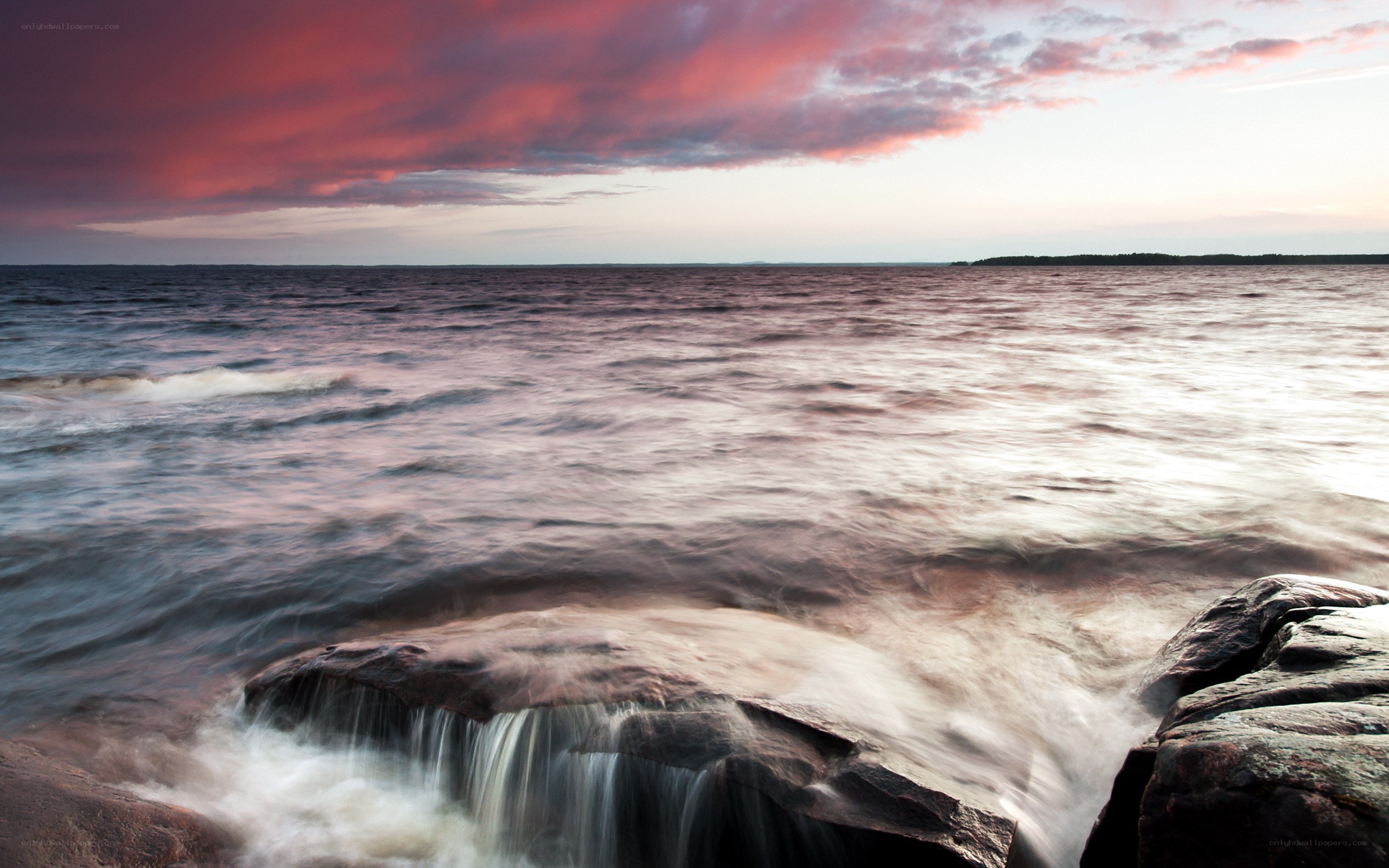 Sunset over rocky shoreline