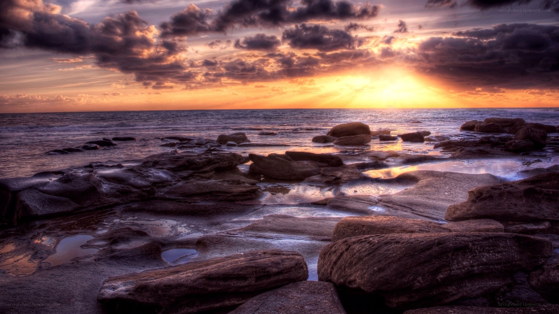 Sunset over rocky shoreline