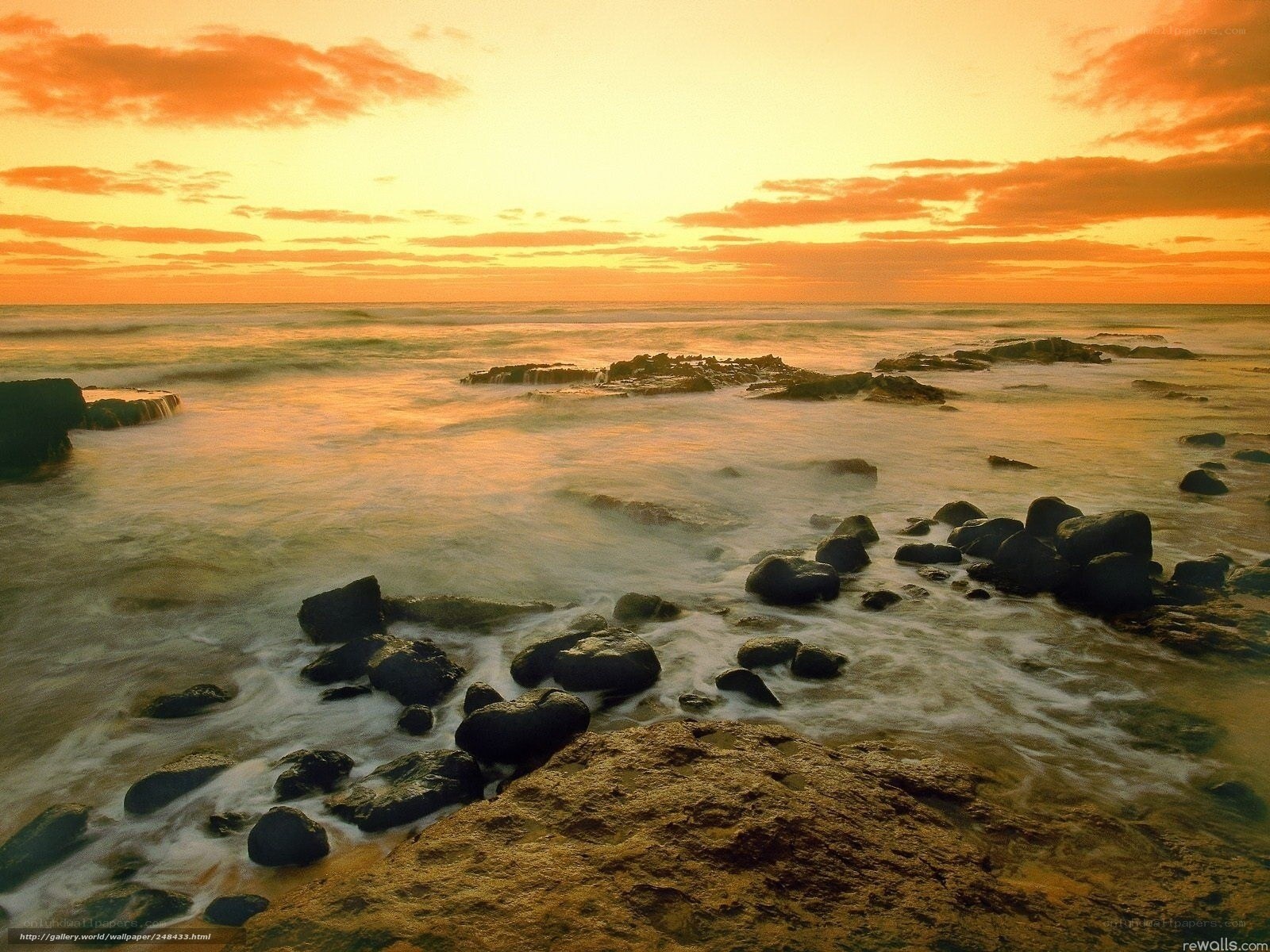 sunset over rocky shoreline
