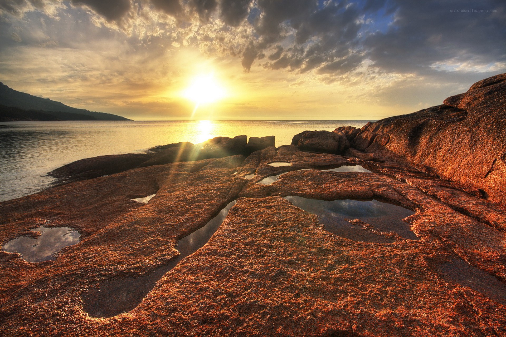 Sunset over rocky shoreline