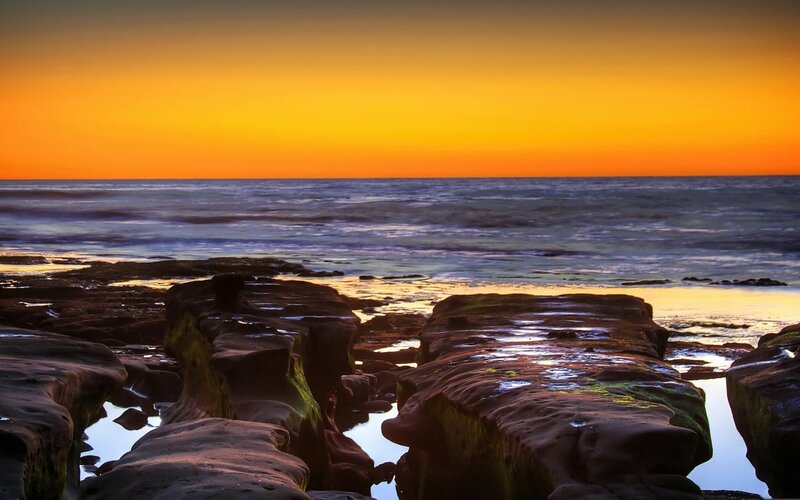 Sunset over rocky shoreline