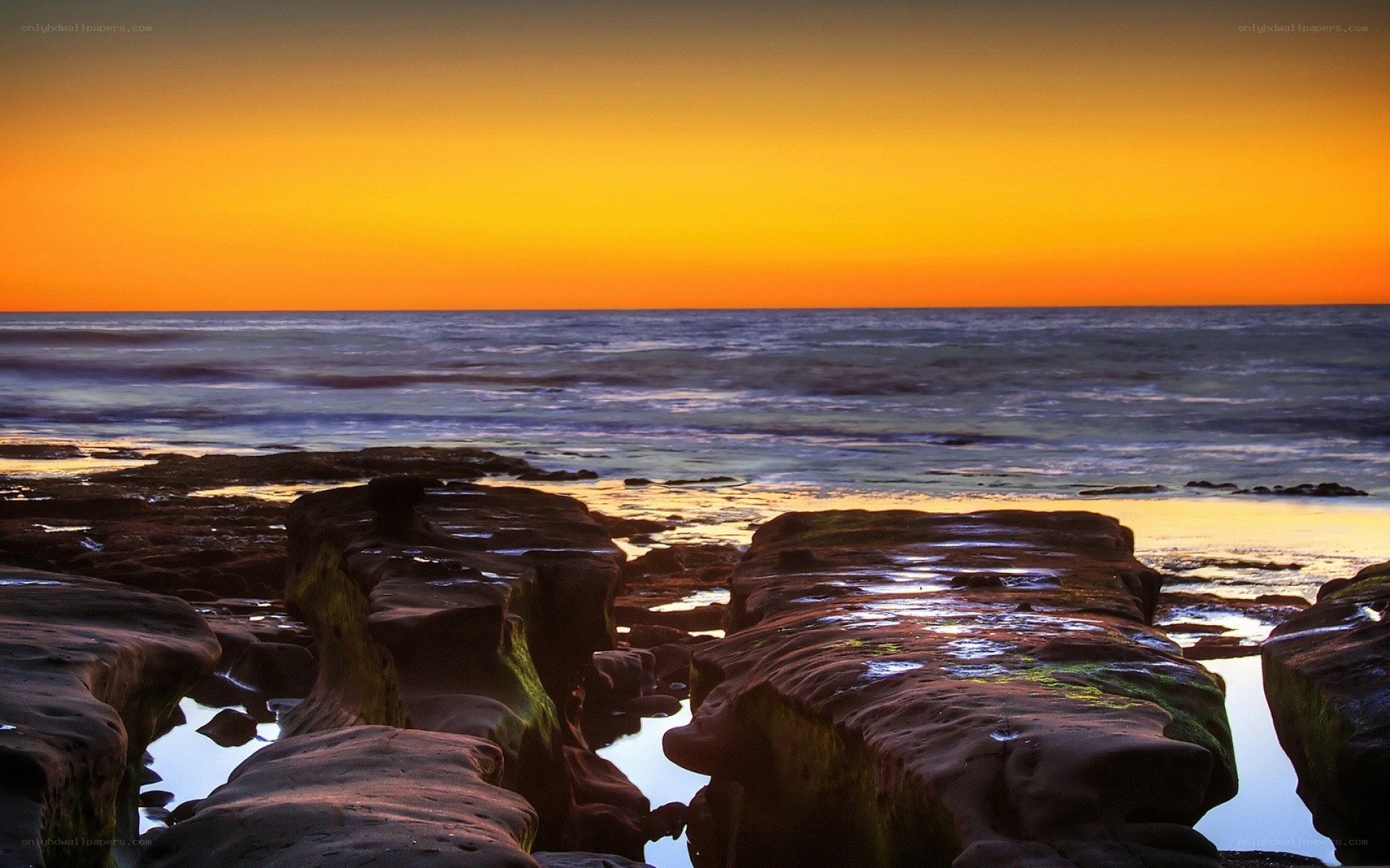 Sunset over rocky shoreline