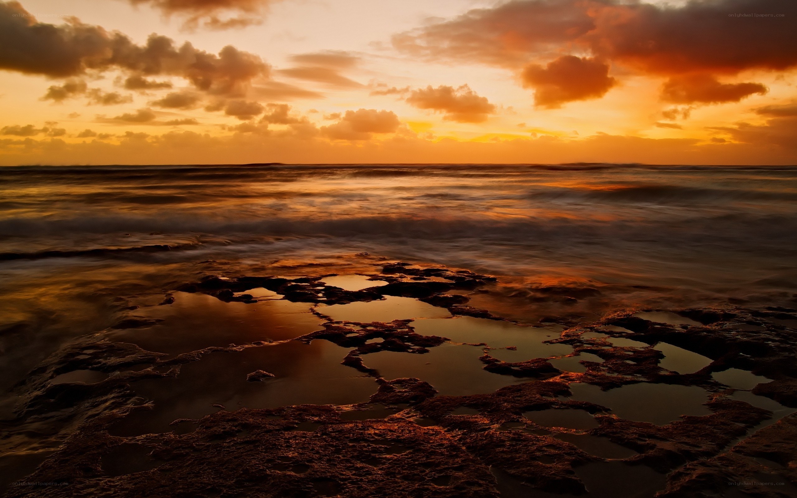 Sunset over rocky shoreline