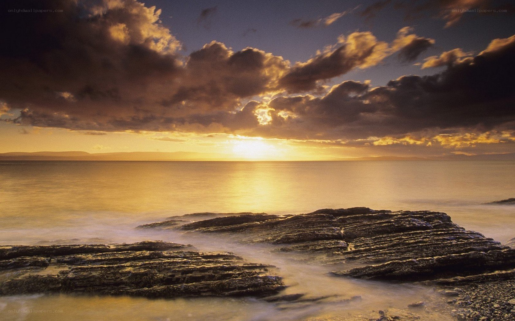 Sunset over rocky shoreline