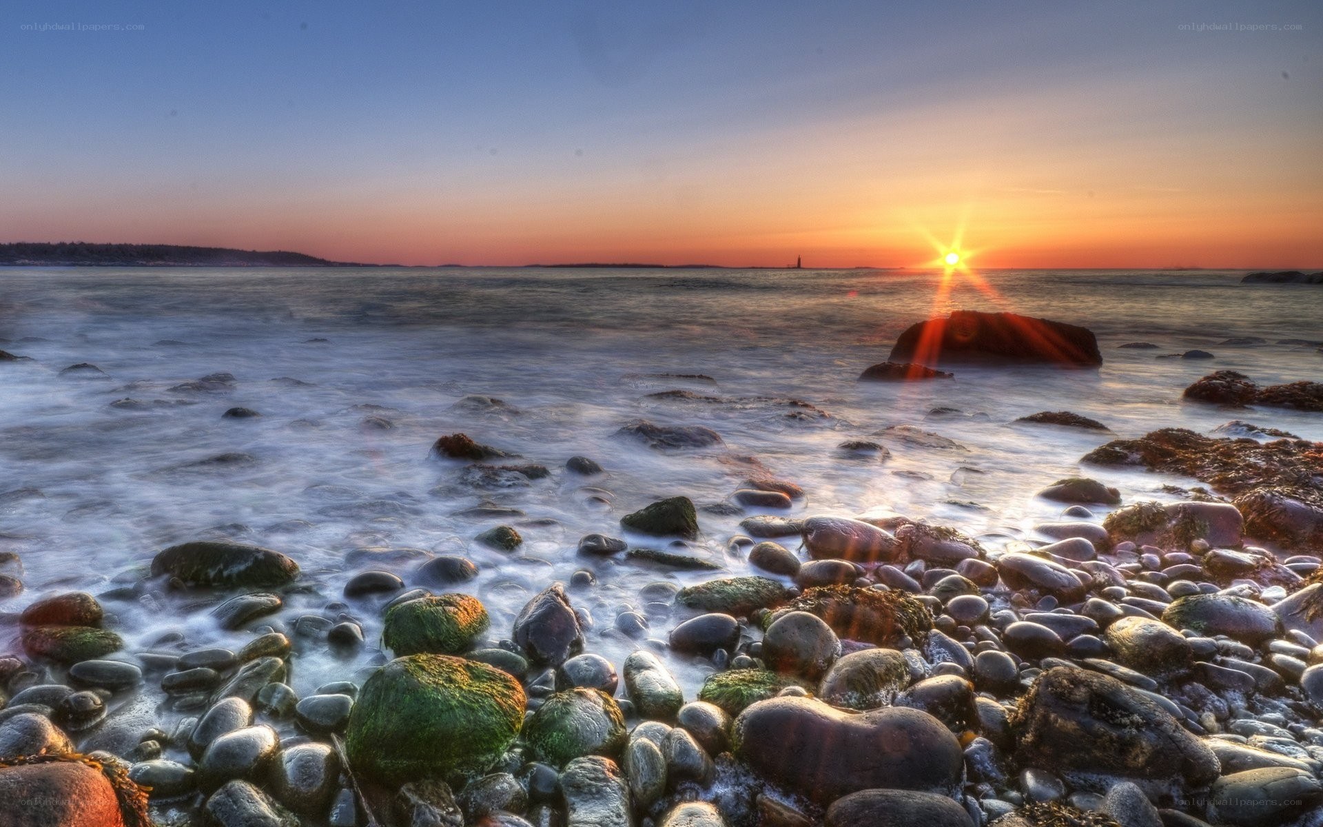 Sunset over rocky shoreline