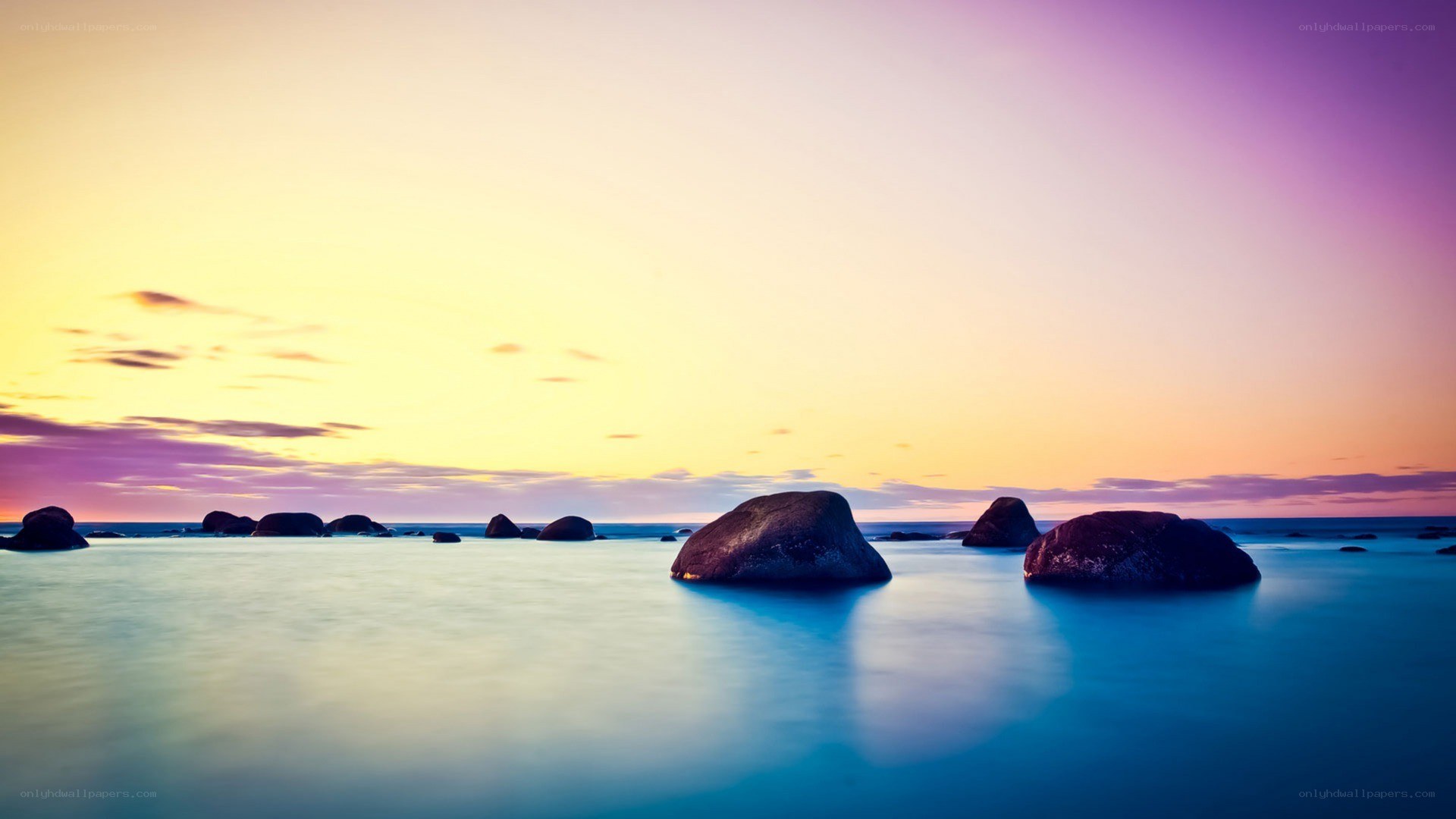 Sunset over rocky shoreline