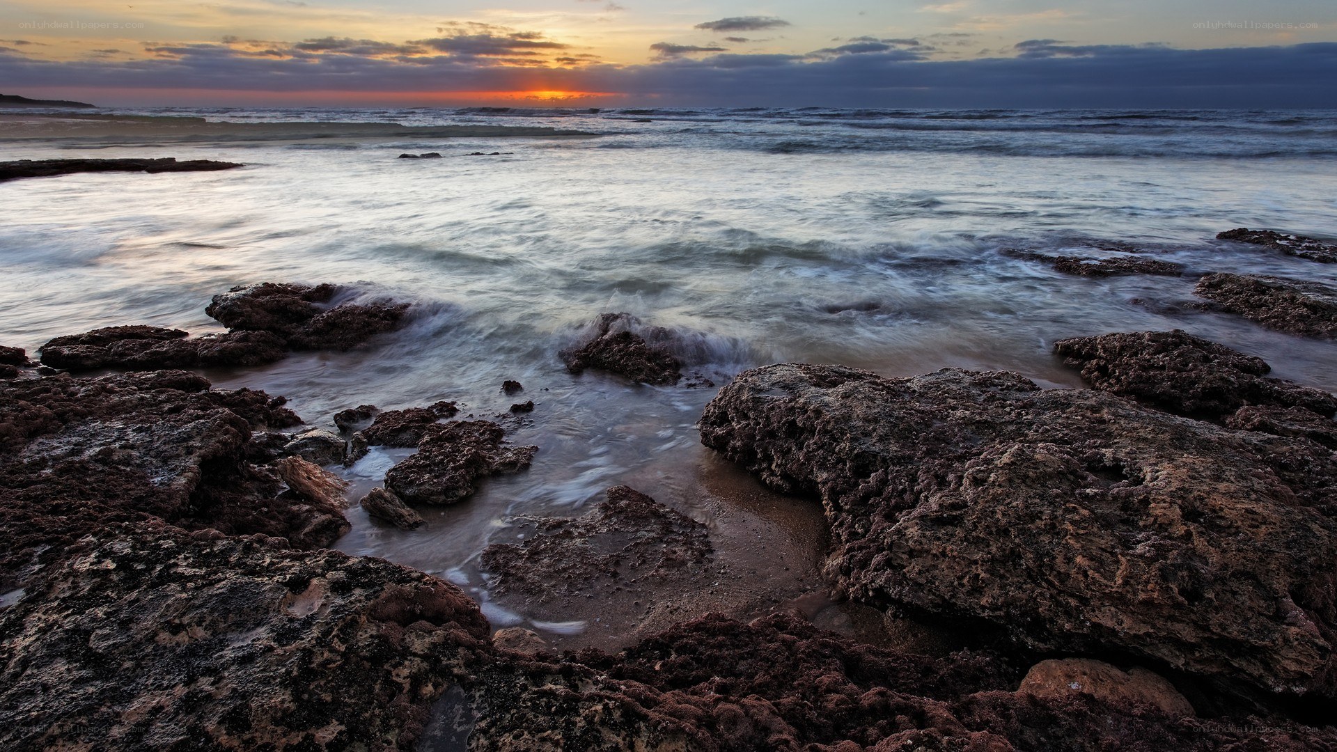 Sunset over rocky shoreline