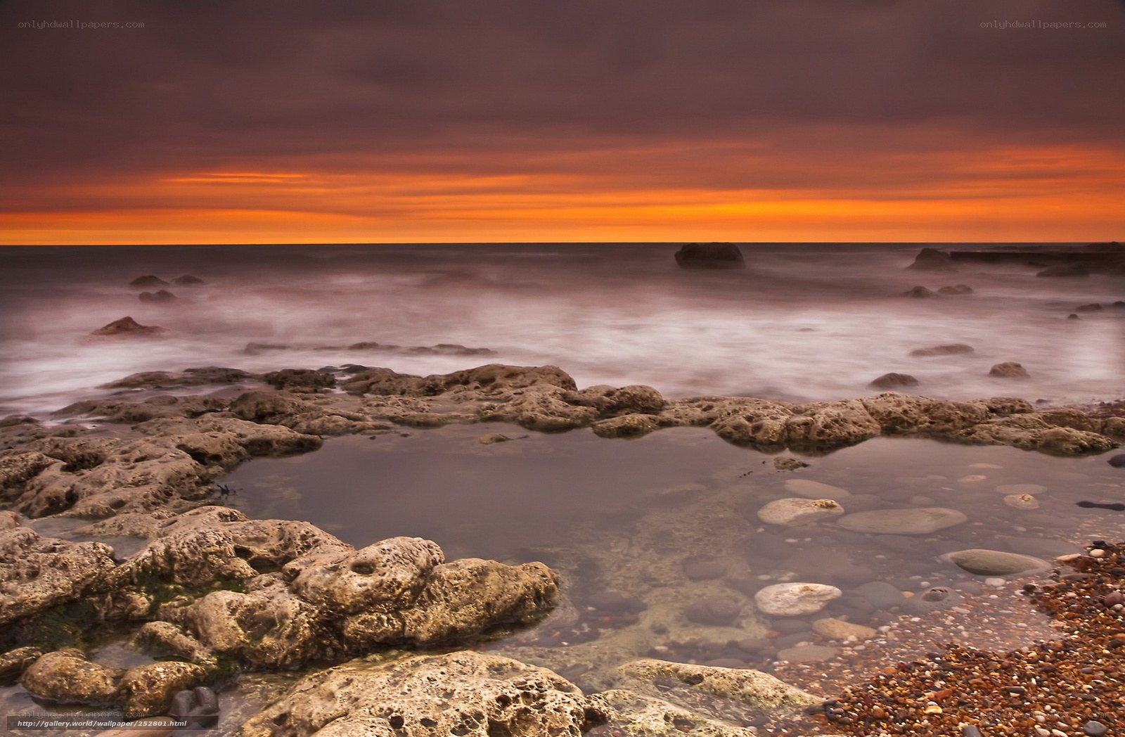 Sunset over rocky shoreline