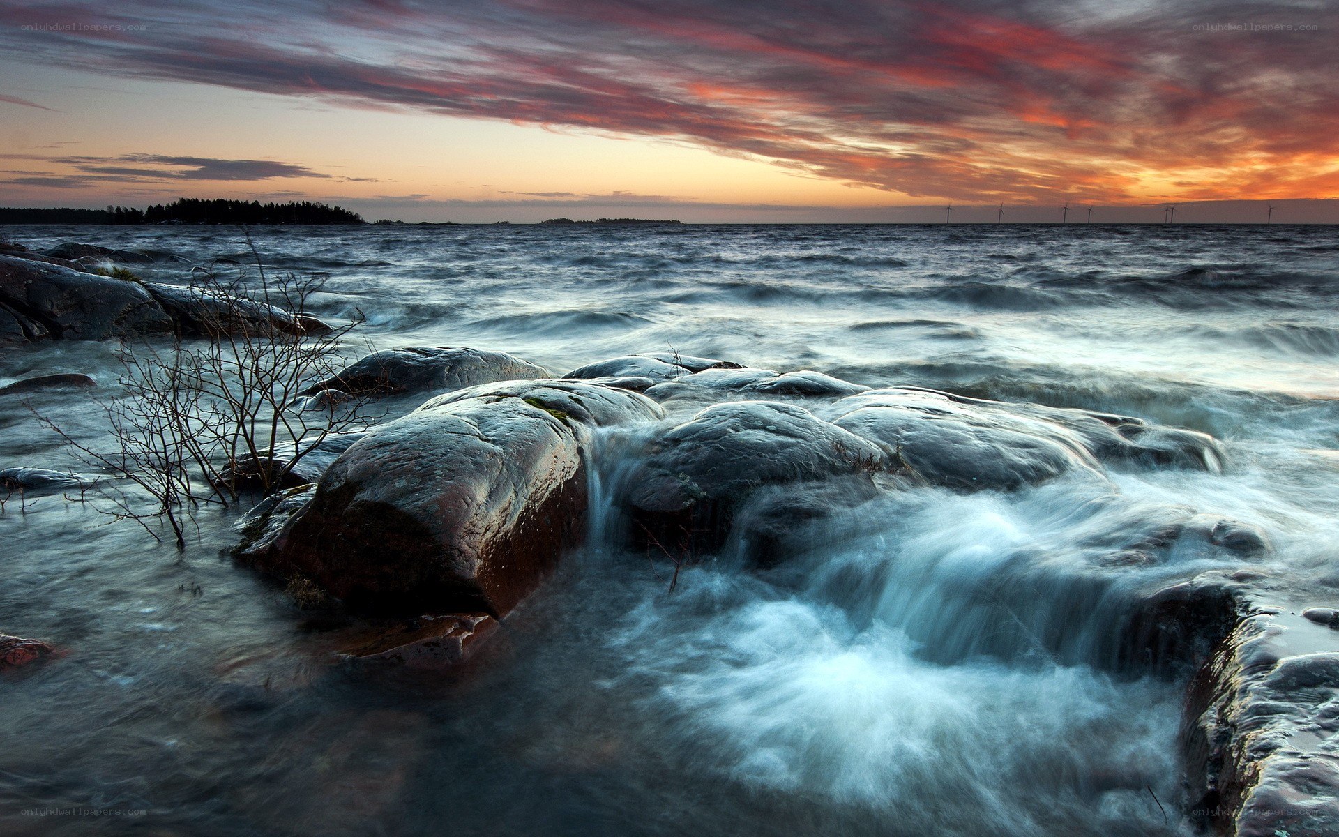 Sunset over rocky shoreline