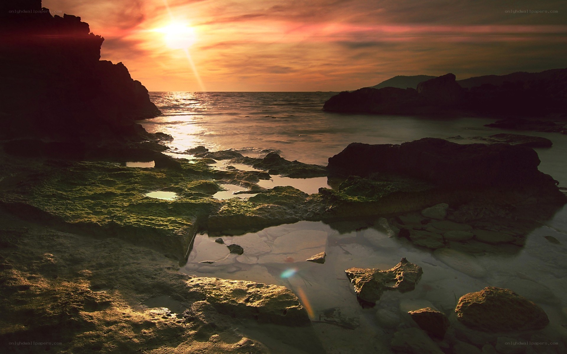 Sunset over rocky shoreline