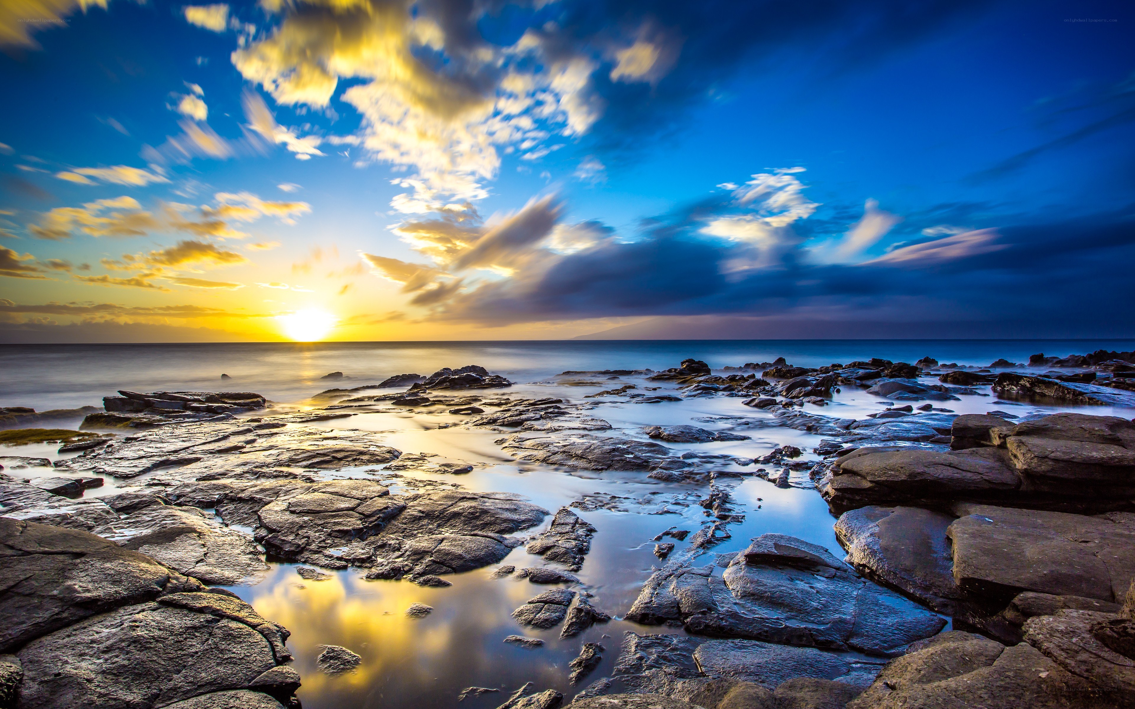 Sunset over rocky shoreline