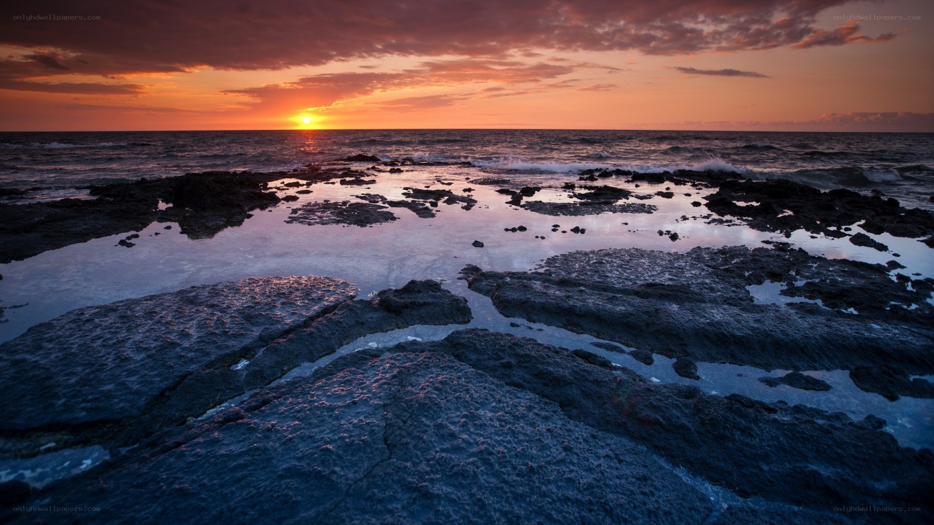 sunset over rocky shoreline