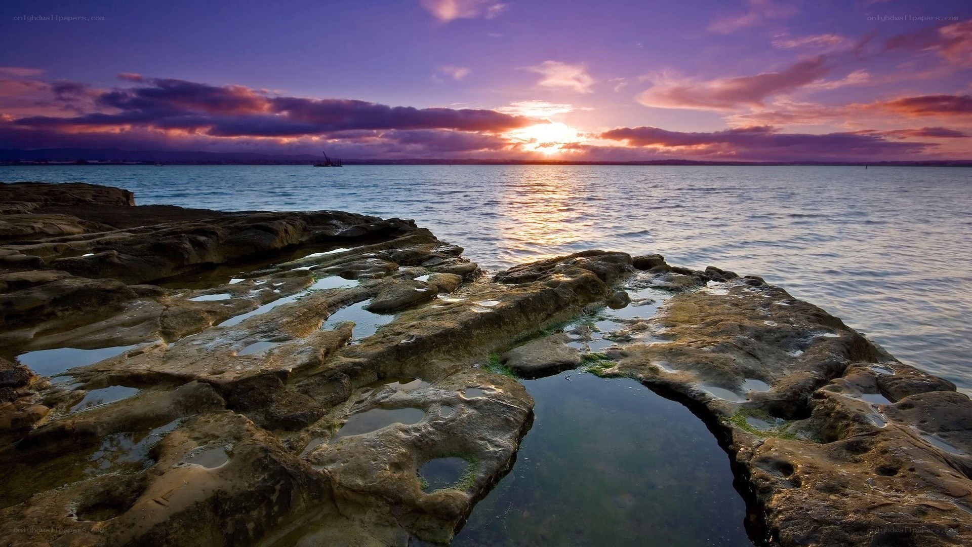 Sunset over rocky shoreline