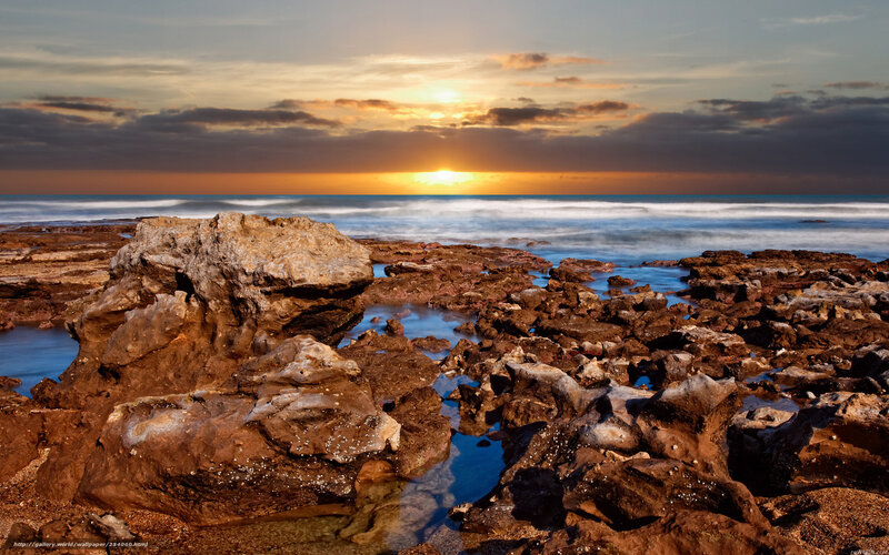 Sunset over rocky shoreline