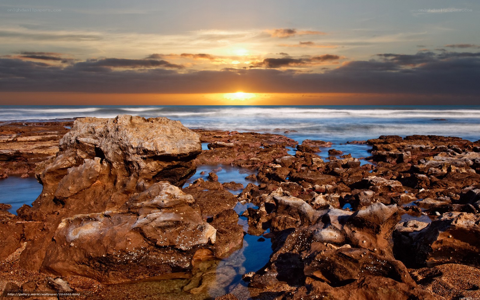 Sunset over rocky shoreline