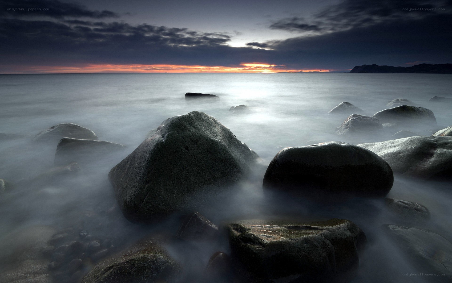 Sunset over rocky shoreline