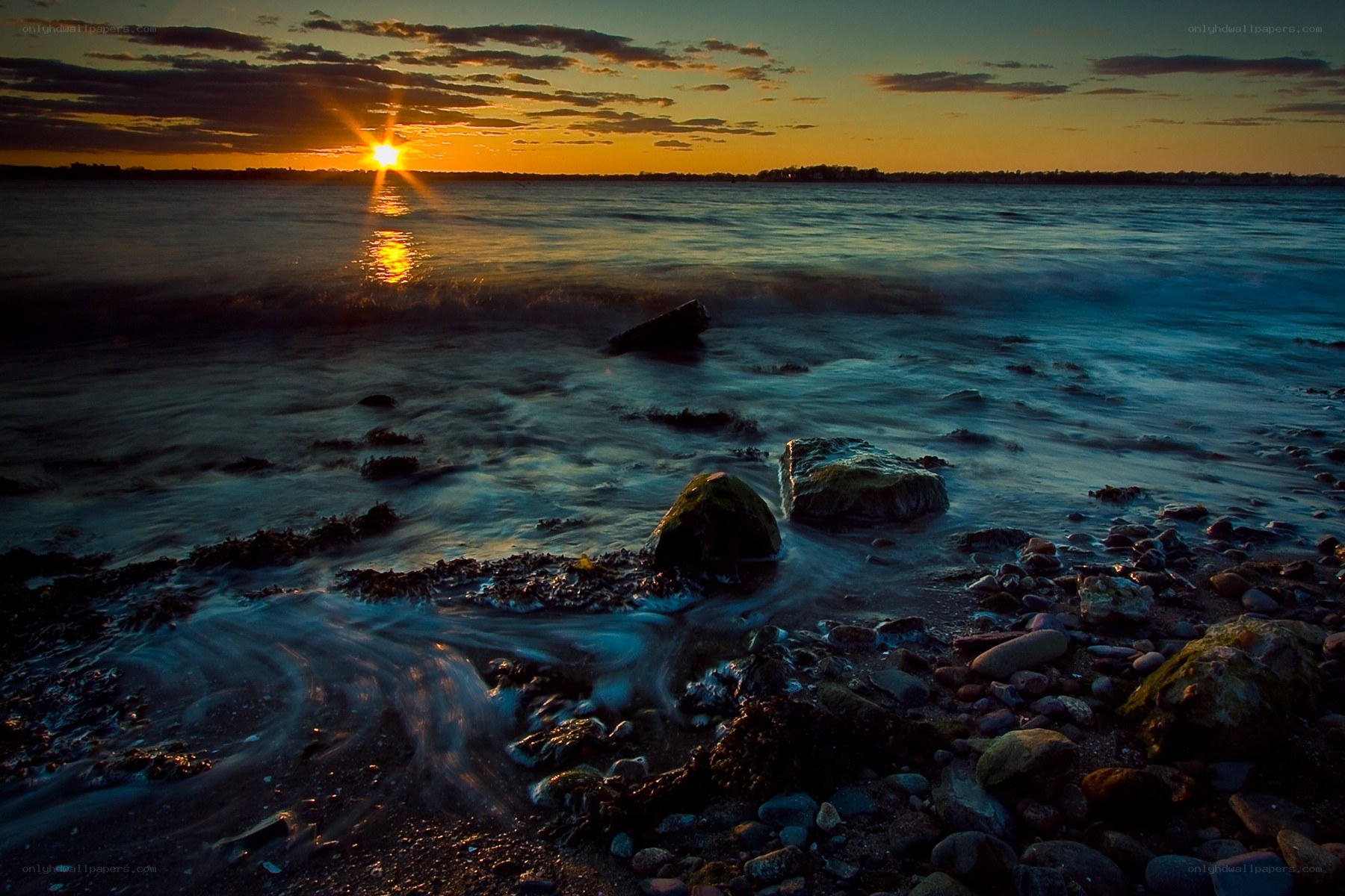 Sunset over rocky shoreline
