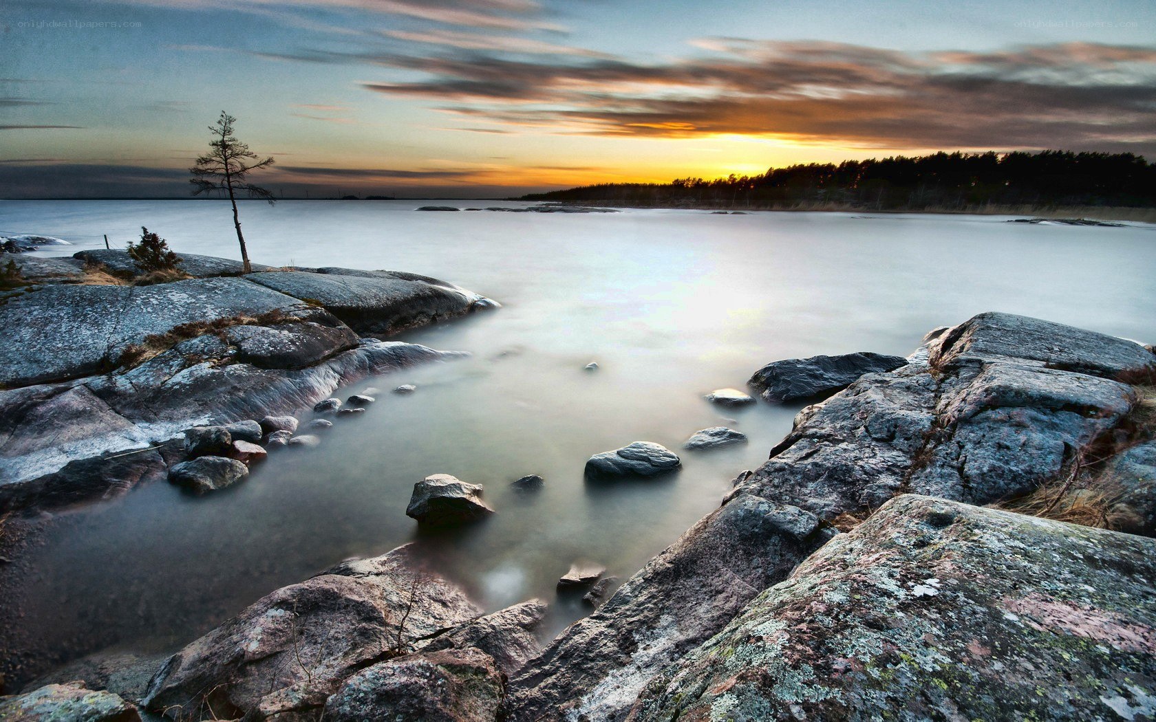 Sunset over rocky shoreline