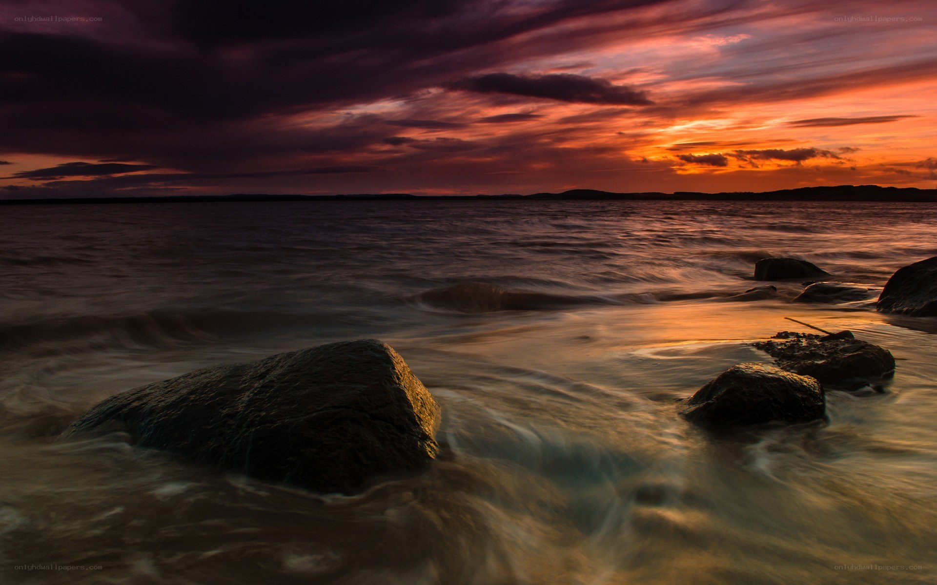 Sunset over rocky shoreline