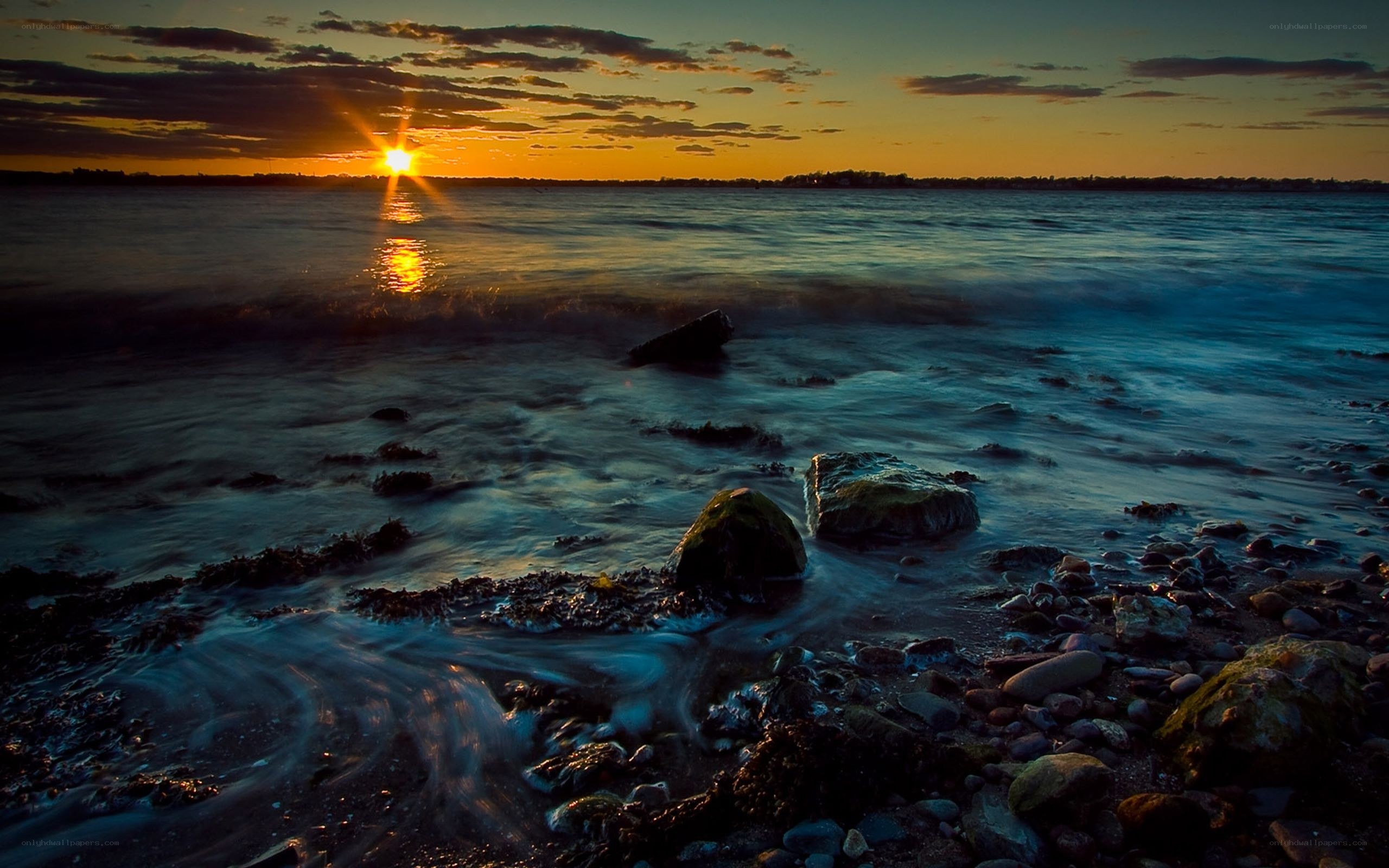 Sunset over rocky shoreline